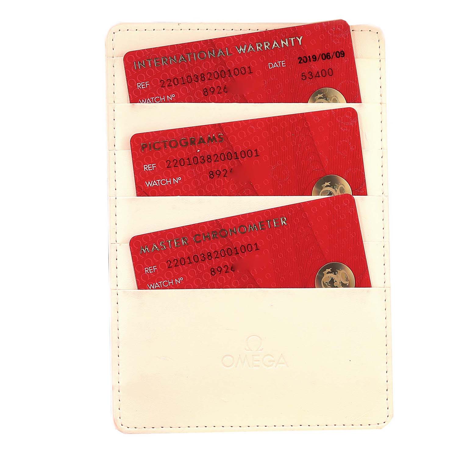 The image shows three red cards (International Warranty, Pictograms, Master Chronometer) in a white Omega cardholder for the Aqua Terra model.