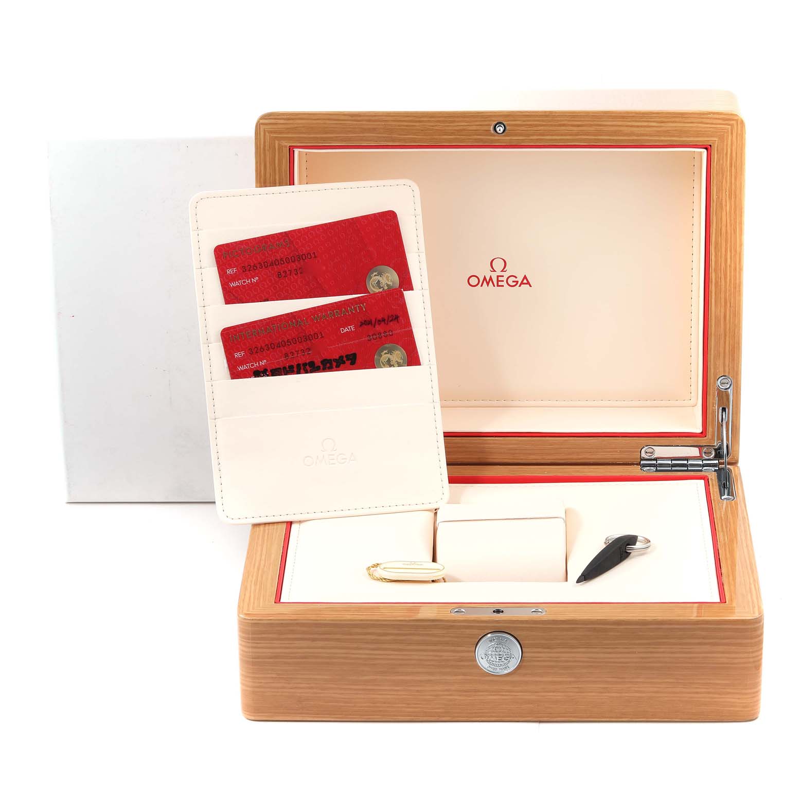 The image shows the accessories and packaging of an Omega Speedmaster 326.30.40.50.03.001 Men
s Stainless Steel Blue Dial 326.30.40.50.03.001 Men
s Stainless Steel Blue Dial watch, including the box, warranty cards, manual, and key.