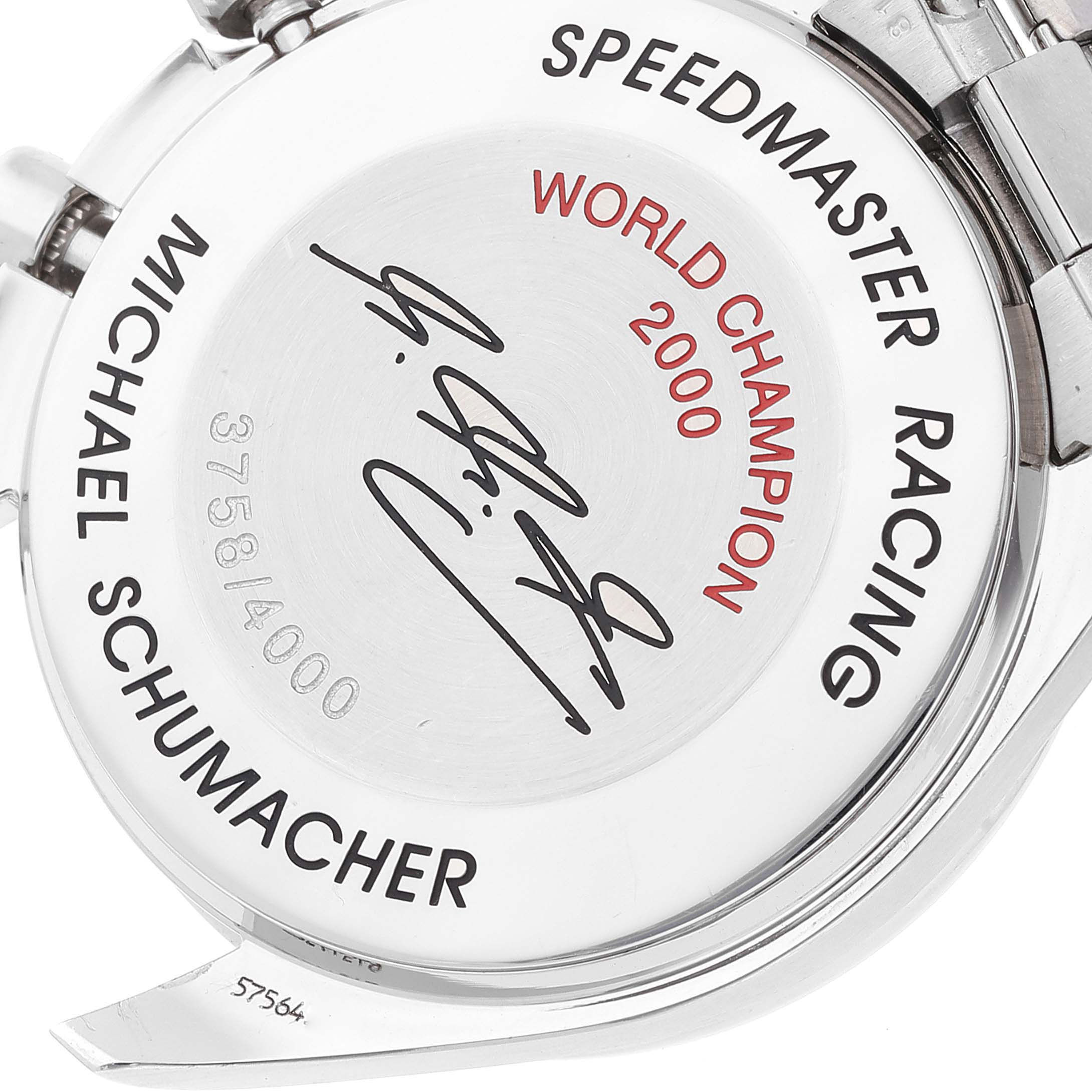 The image shows the back of an Omega Speedmaster 3517.30.00 Men's Stainless Steel Silver Dial 3517.30.00 Men's Stainless Steel Silver Dial Racing watch, featuring an engraving and a signature.