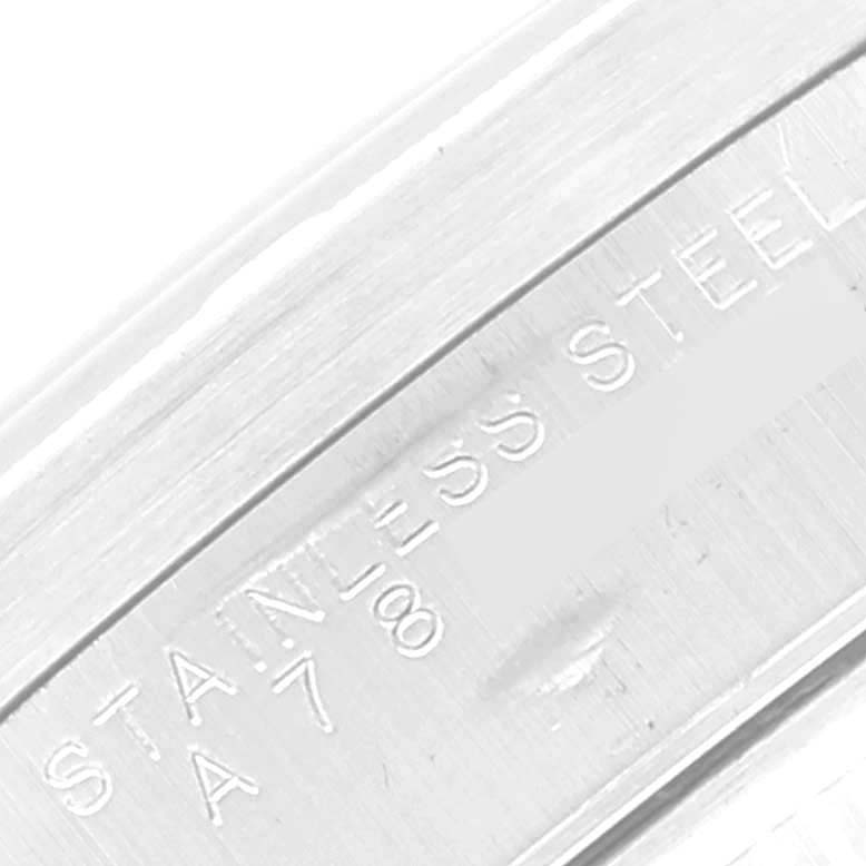 This close-up image shows the "STAINLESS STEEL" engraving on the band of the Rolex Air-King 14010 Men's Stainless Steel Pink Dial 14010 Men's Stainless Steel Pink Dial watch.