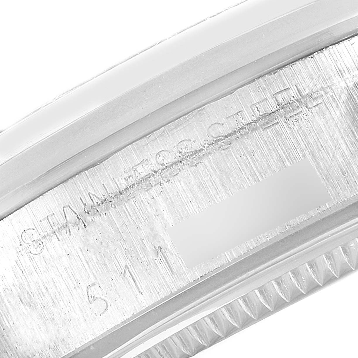 This image shows a close-up of the caseback edge of a Rolex Vintage Collection 5500 Men's Stainless Steel Silver Dial 5500 Men's Stainless Steel Silver Dial model, highlighting "STAINLESS STEEL" and part of the serial number.