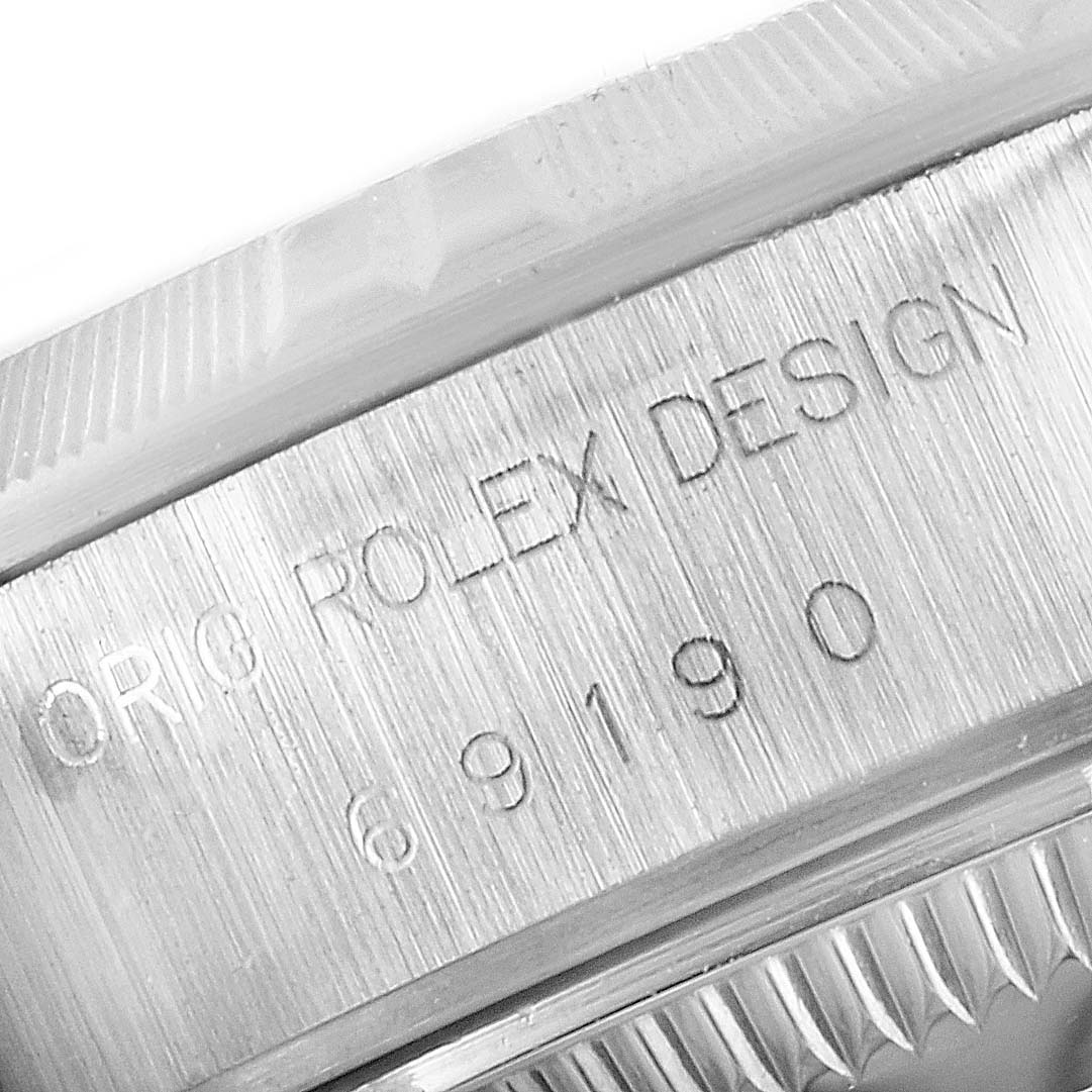 This image shows a close-up of the engraving on the case side of the Rolex Date 69190 Women's Stainless Steel Grey Dial 69190 Women's Stainless Steel Grey Dial model watch.