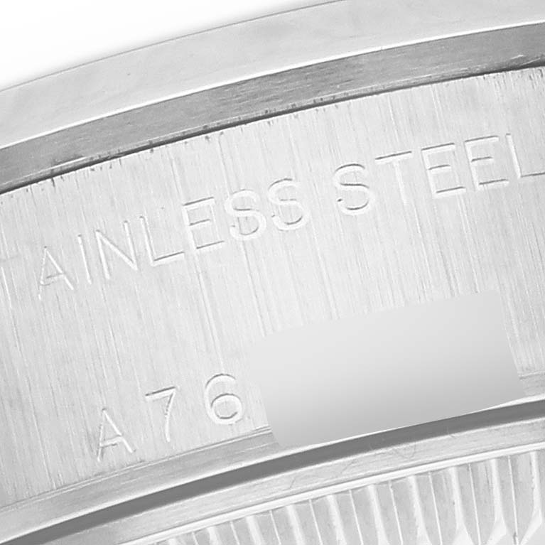 This image shows a close-up of the case back engraving on a Rolex Date 79160 Women's Stainless Steel Silver Dial 79160 Women's Stainless Steel Silver Dial model, highlighting the "Stainless Steel" inscription and part of the serial number.