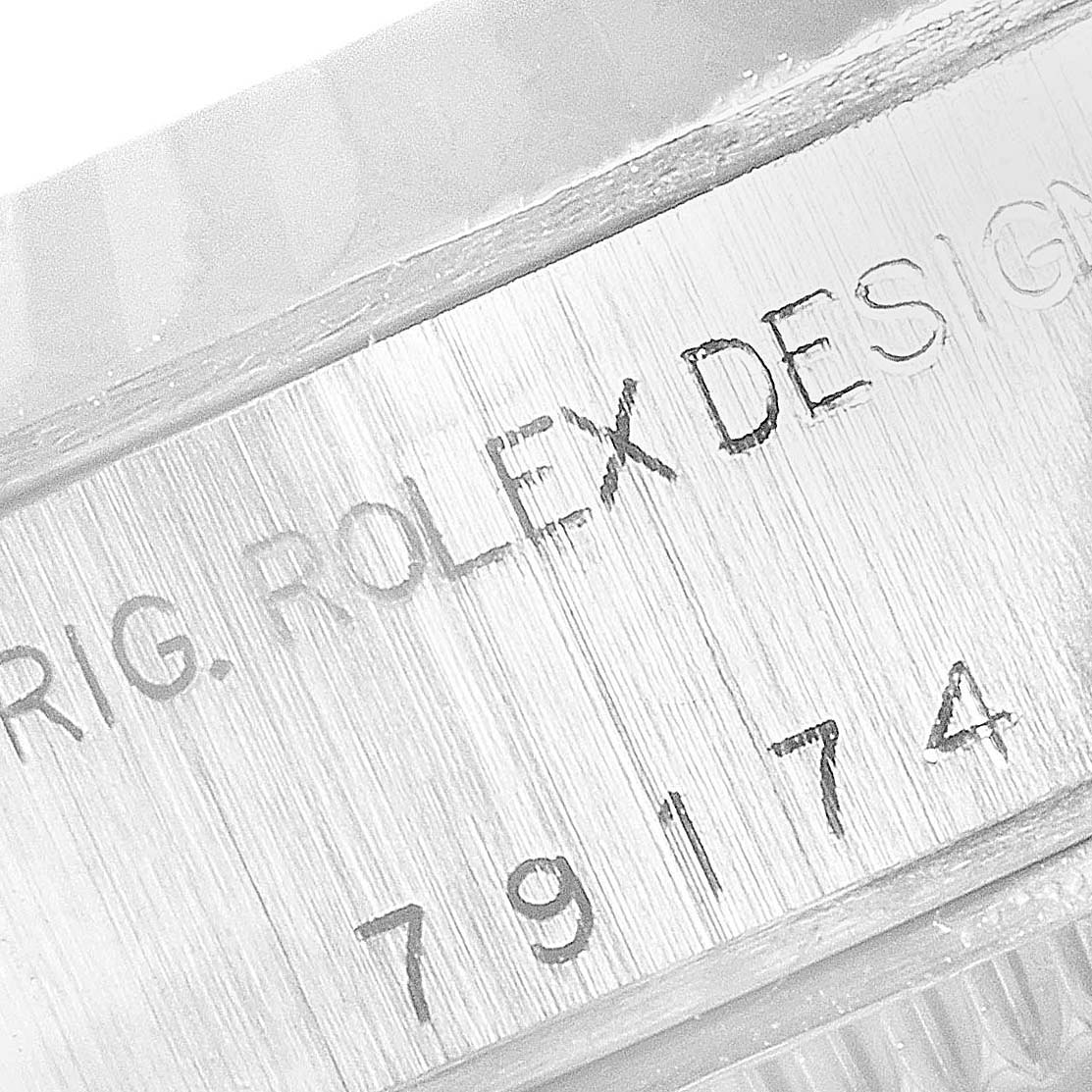 The image shows a close-up of the inner bezel of a Rolex Datejust 79174 Women
s Stainless Steel Silver Dial 79174 Women
s Stainless Steel Silver Dial watch, displaying the engraved model number.