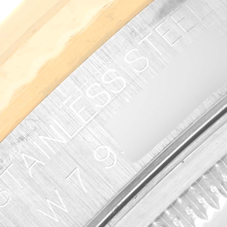 The image shows a macro view of the side of a Rolex Datejust 16233 Men
s Steel and Gold (two tone) Champagne Dial 16233 Men
s Steel and Gold (two tone) Champagne Dial watch, highlighting the stainless steel and gold detailing.