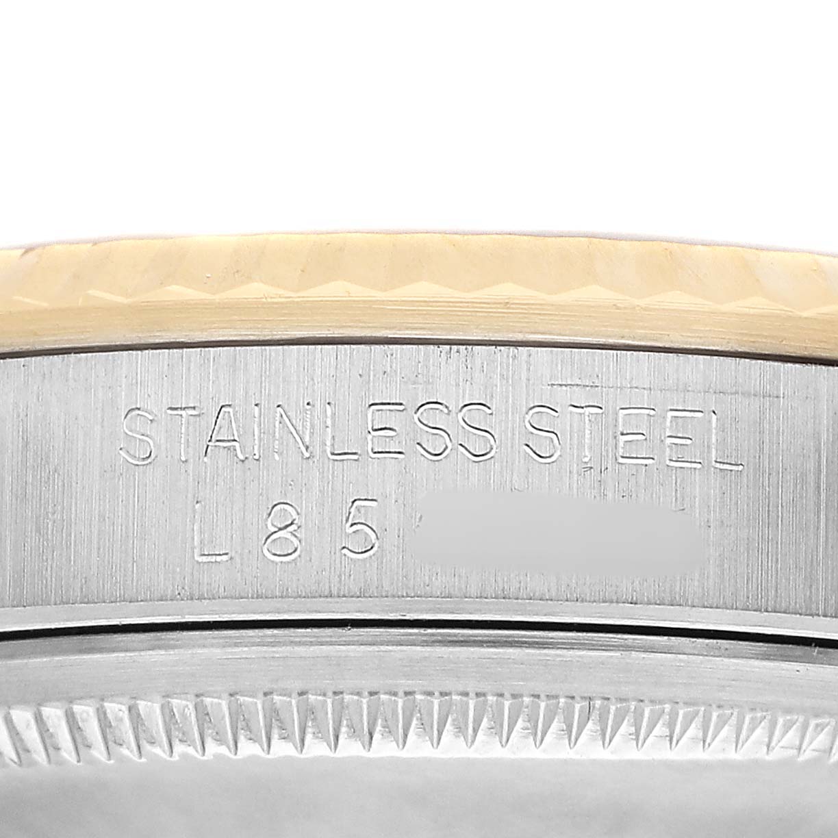 The image shows a close-up of the side engraving and fluted bezel of a Rolex Datejust 16233 Men's Steel and Gold (two tone) Champagne Dial watch.