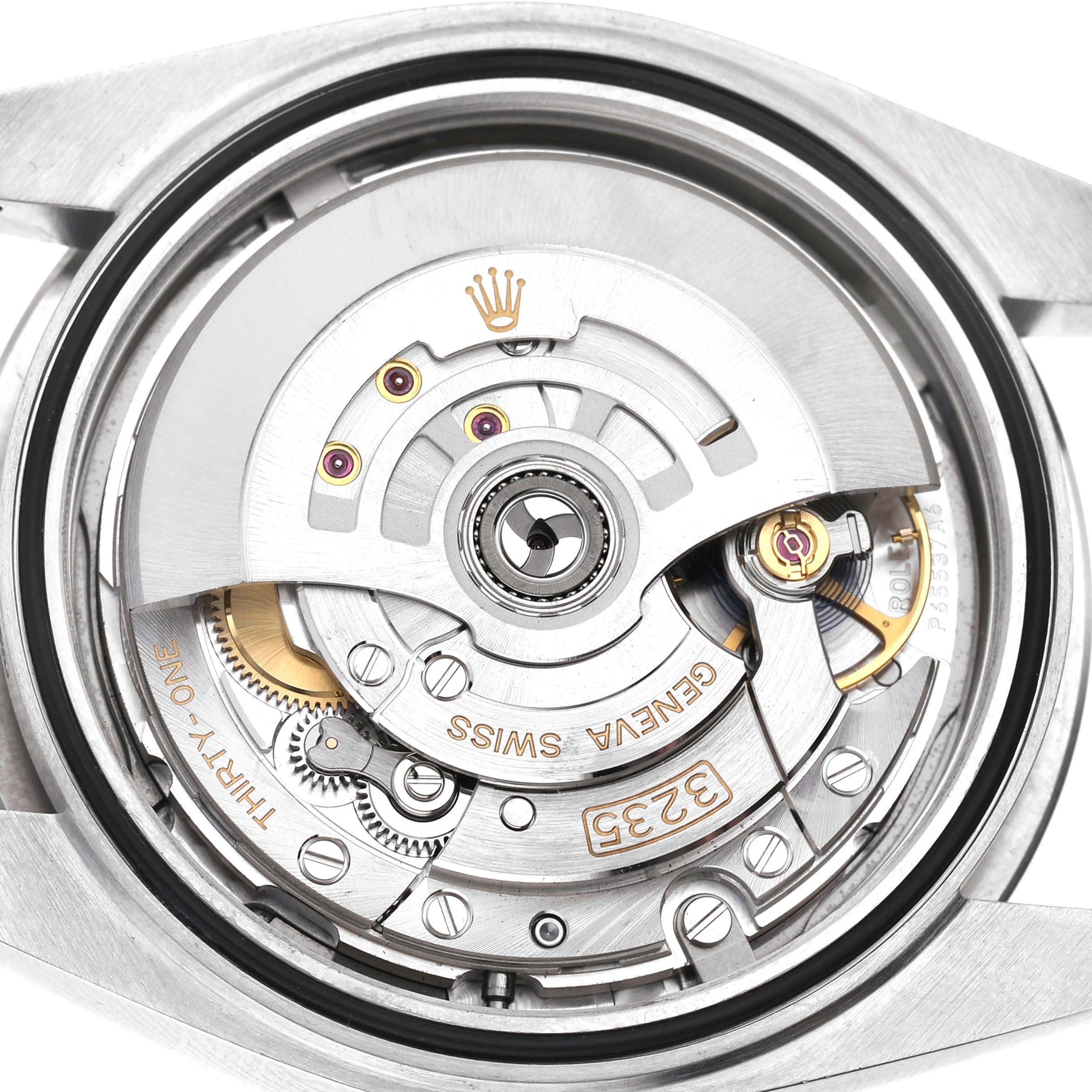 This image shows the movement of a Rolex Datejust 41 126300 Men's Stainless Steel Grey Dial, including the rotor and various gears, viewed from the back.
