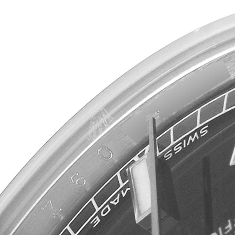 The image shows a close-up of the bezel and part of the dial of a Mid-Size Rolex watch.