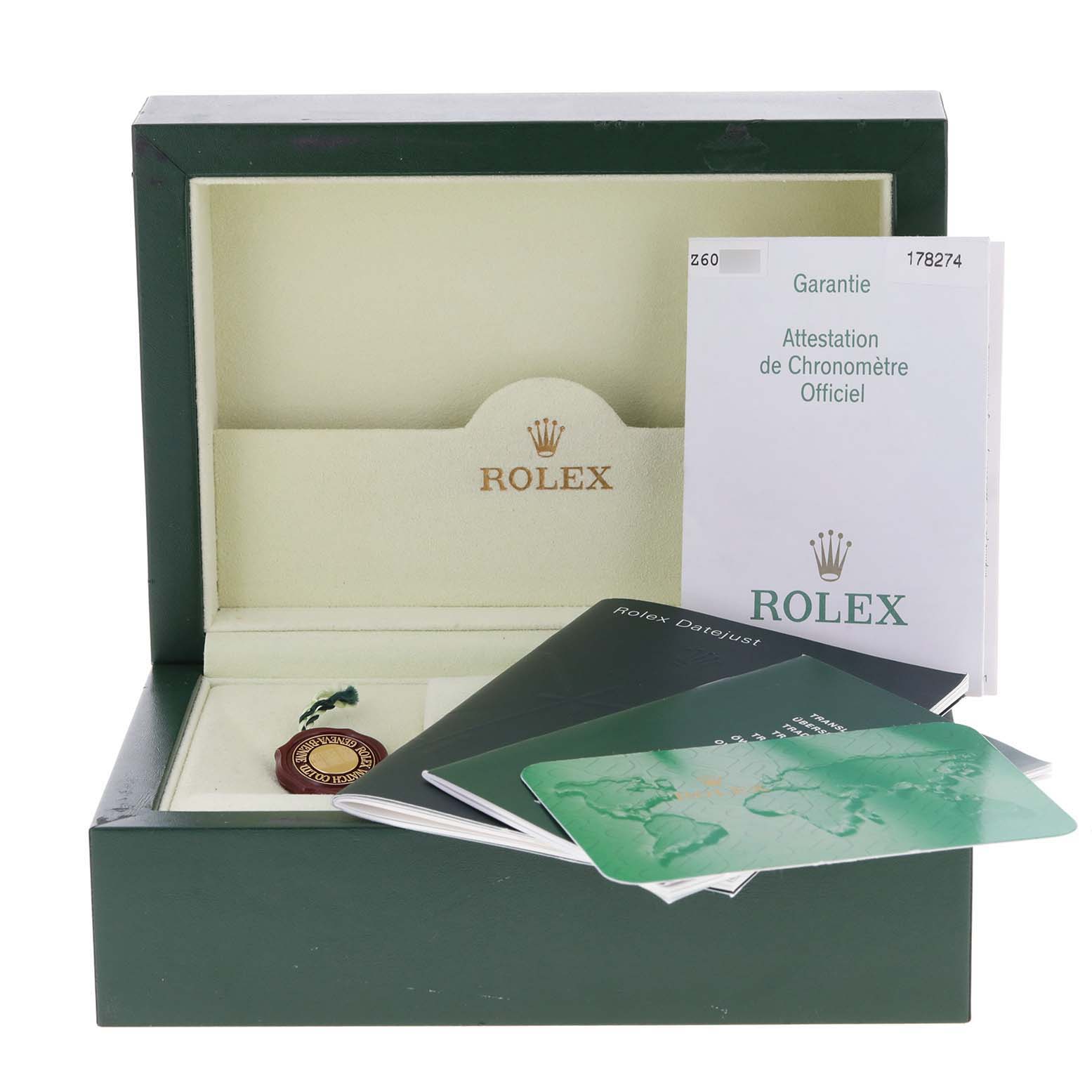 The image shows the open box and accessories, including booklets and a tag, for a Mid-Size Rolex watch.