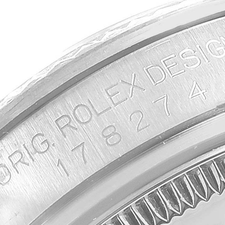 This close-up image shows the engraved serial number on the case back of a Rolex Mid-Size 178274 Women
s Stainless Steel Black Dial 178274 Women
s Stainless Steel Black Dial watch.