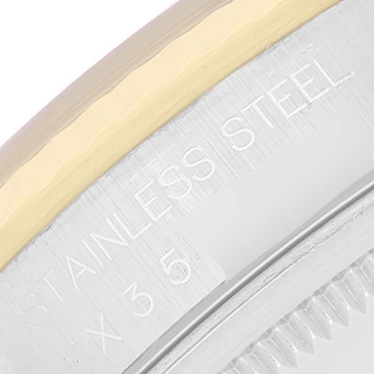 This close-up image shows the edge inscription and part of the bezel of a Rolex Datejust 16233 Men's Steel and Gold (two tone) Black Dial 16233 Men's Steel and Gold (two tone) Black Dial watch.