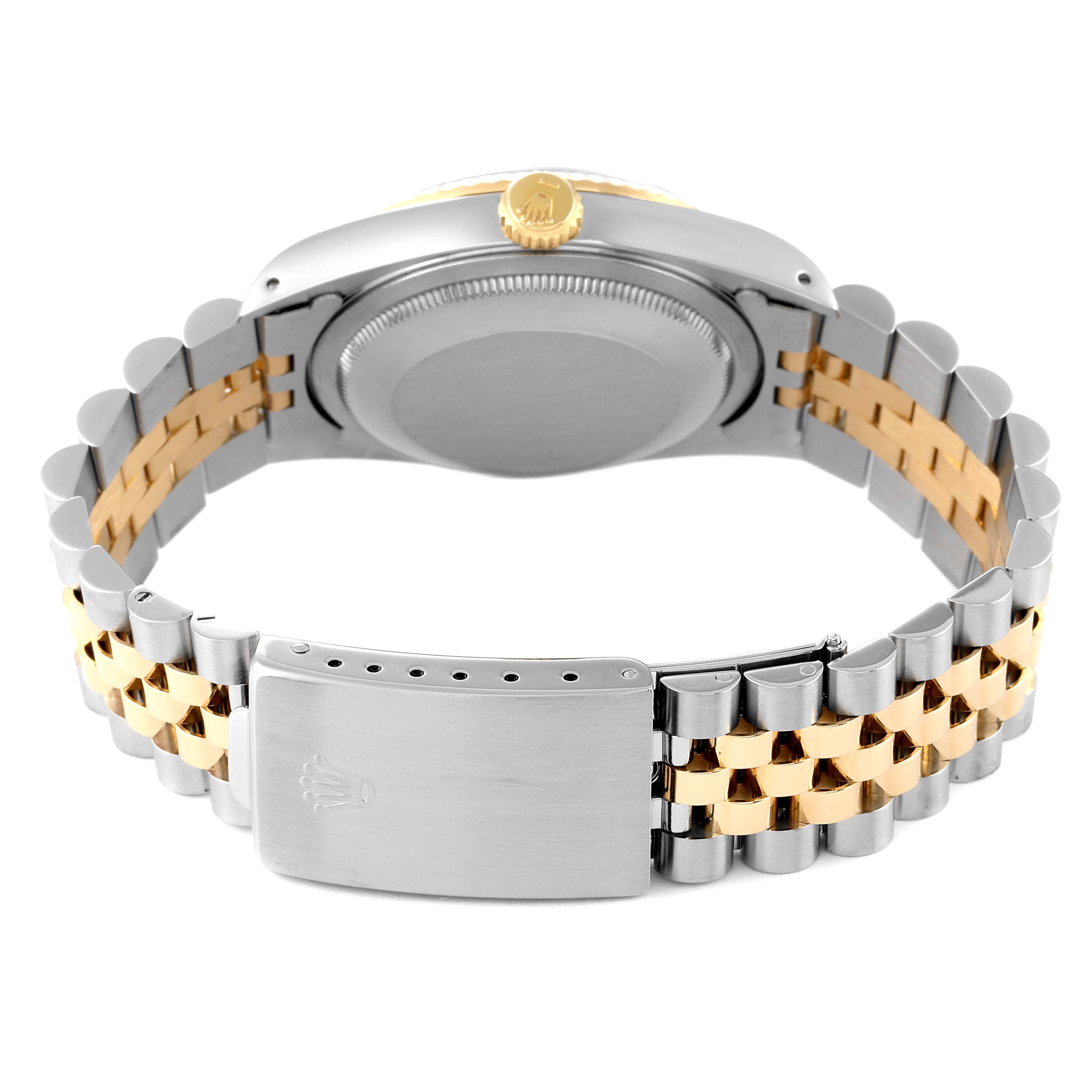 The image shows the backside of a Rolex Datejust 16233 Men's Steel and Gold (two tone) Black Dial 16233 Men's Steel and Gold (two tone) Black Dial, highlighting the stainless steel and gold bracelet and clasp.