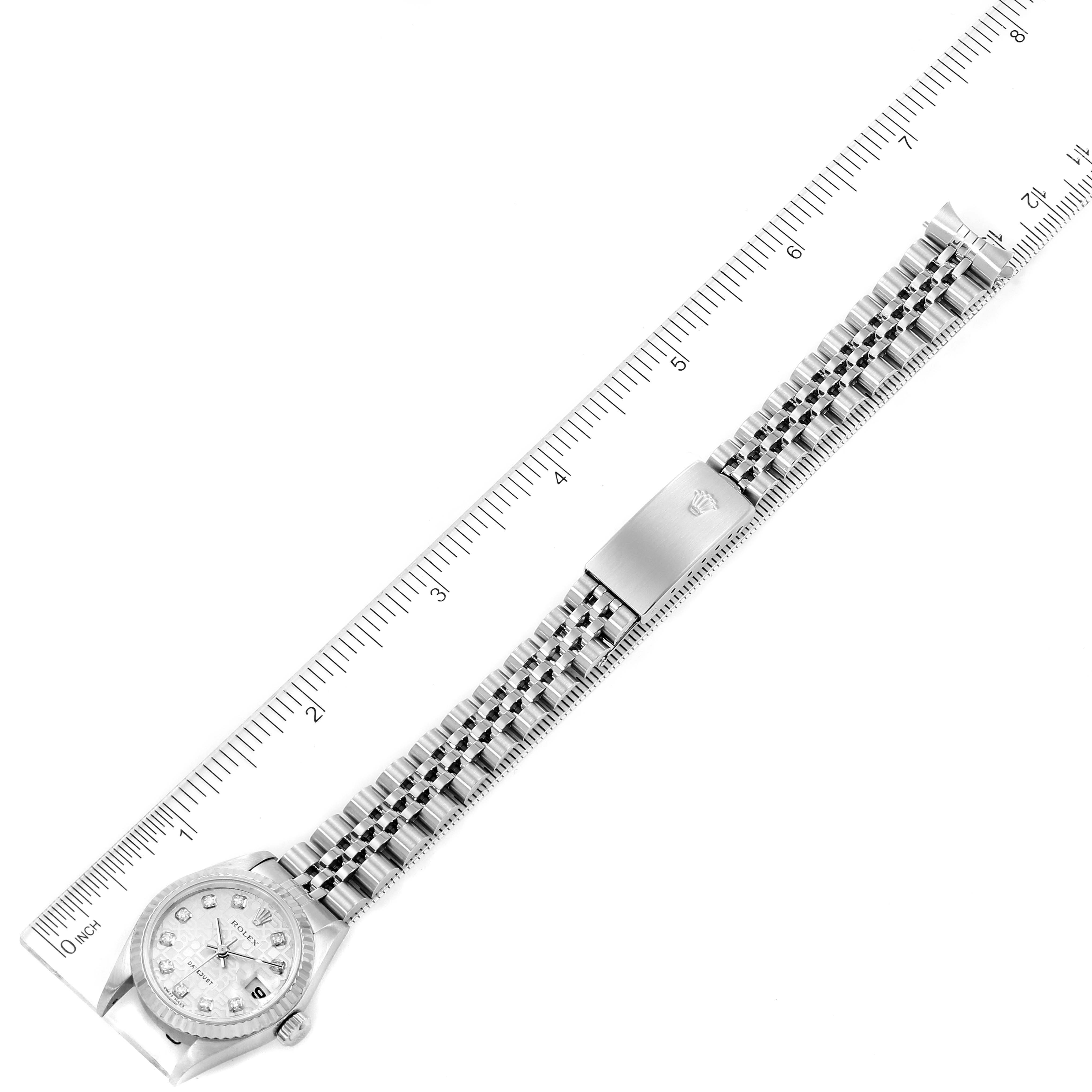 This image shows a top-down view of a Rolex Datejust 79174 Women
s Stainless Steel Silver Dial 79174 Women
s Stainless Steel Silver Dial watch, including its bracelet, clasp, and part of the face with a ruler for scale.