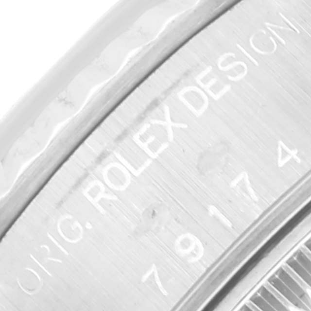 This close-up image shows the engraved markings on the bezel of a Rolex Datejust 79174 Women's Stainless Steel Pink Dial 79174 Women's Stainless Steel Pink Dial watch.