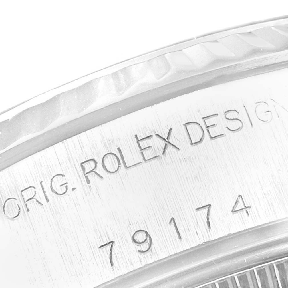 This close-up image shows the engraved serial number and "ORIG. ROLEX DESIGN" on the side of a Rolex Datejust 79174 Women's Stainless Steel Silver Dial 79174 Women's Stainless Steel Silver Dial watch.