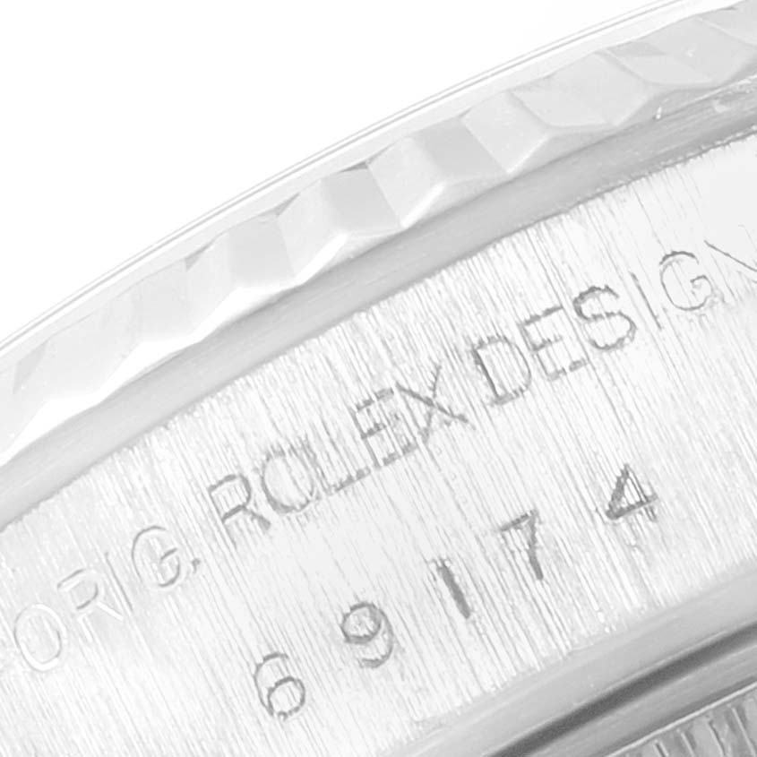 This image shows a close-up of the engraved side of the bezel and case on a Rolex Datejust 69174 Women
s Stainless Steel Silver Dial 69174 Women
s Stainless Steel Silver Dial watch.