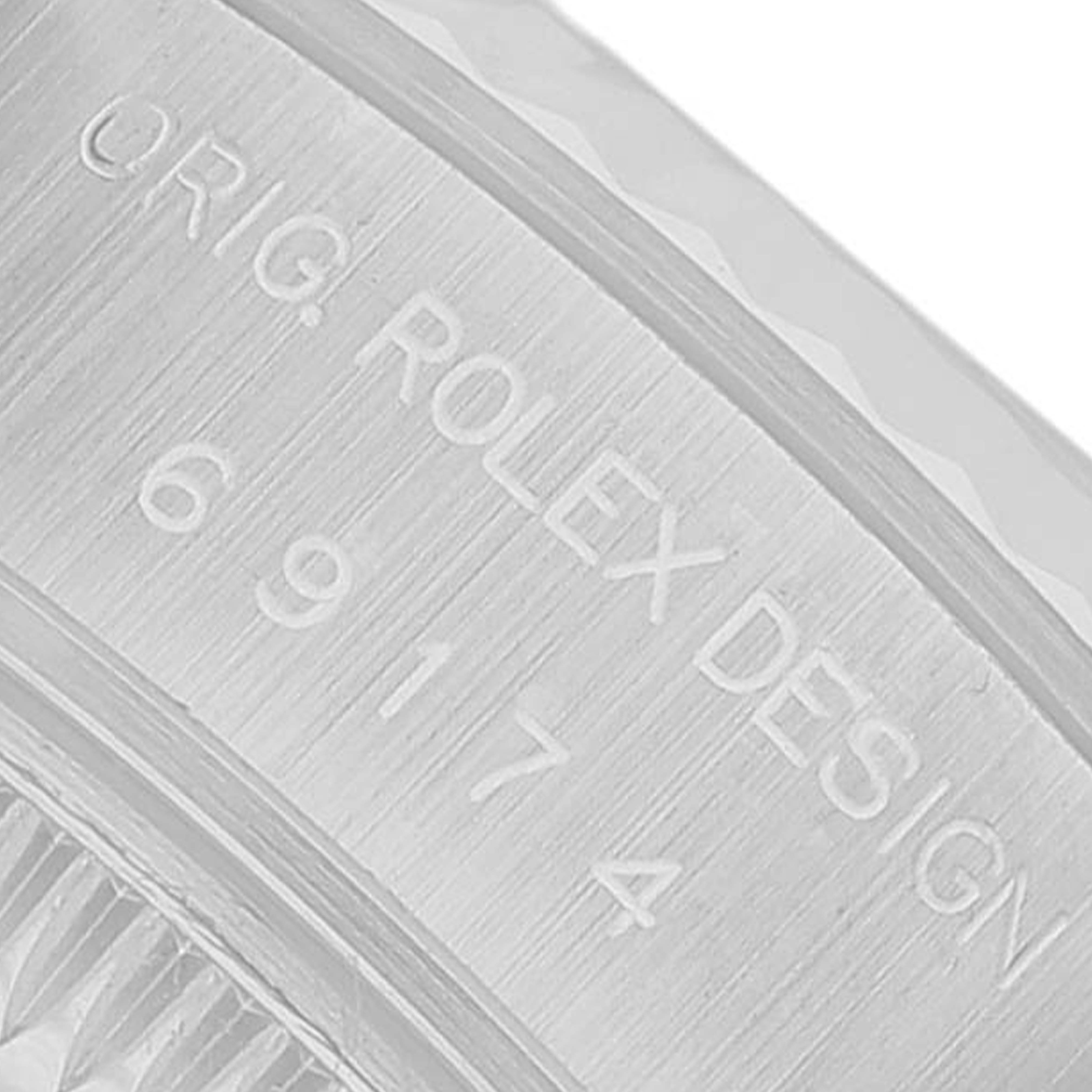 The image shows a close-up of the case side of a Rolex Datejust 69174 Women's Stainless Steel Silver Dial, highlighting the engraved design and model number.