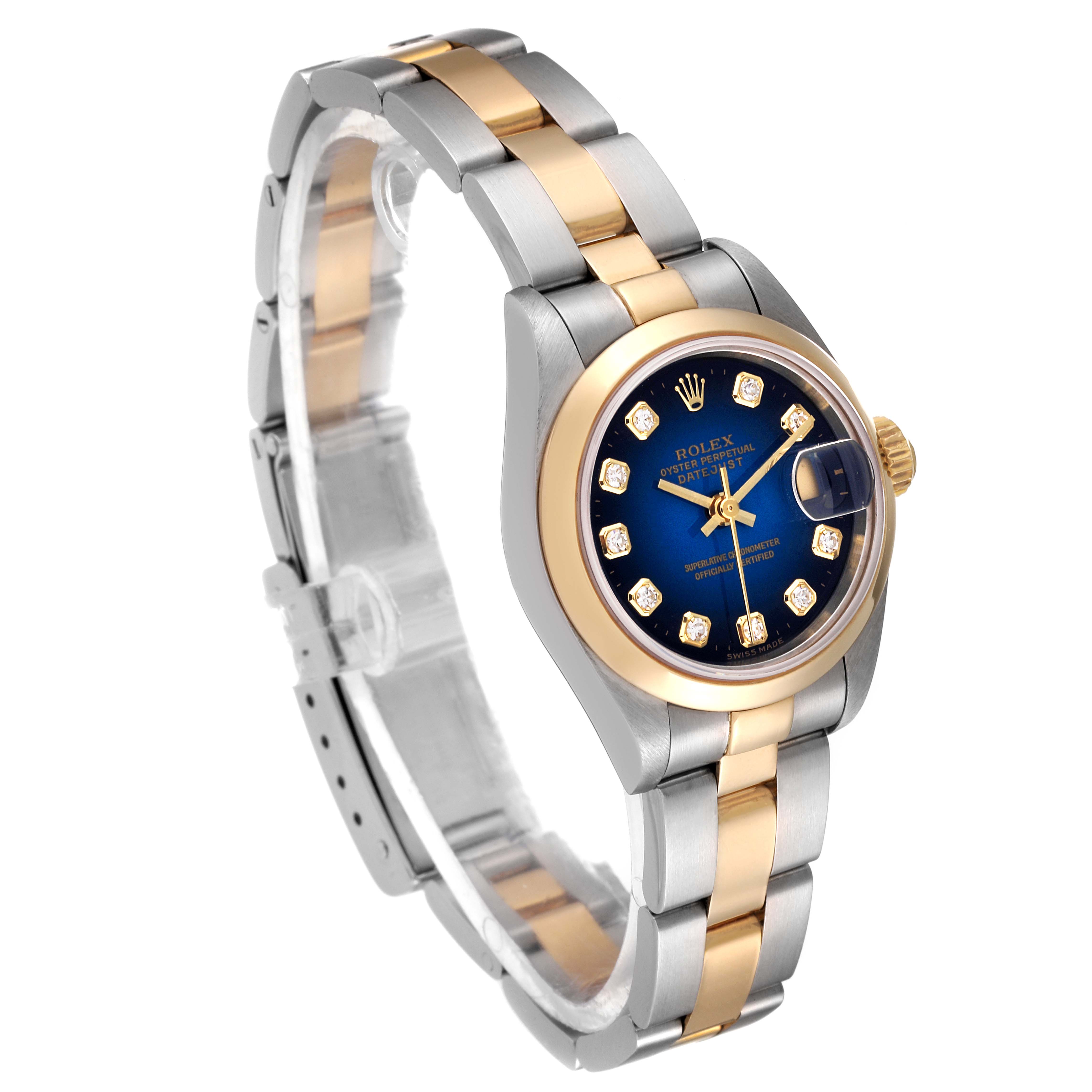 This Rolex Datejust 69163 Women
s Steel and Gold (two tone) Blue Dial 69163 Women
s Steel and Gold (two tone) Blue Dial watch is shown at a three-quarter angle, highlighting its bracelet, bezel, case, and blue dial with diamond markers.