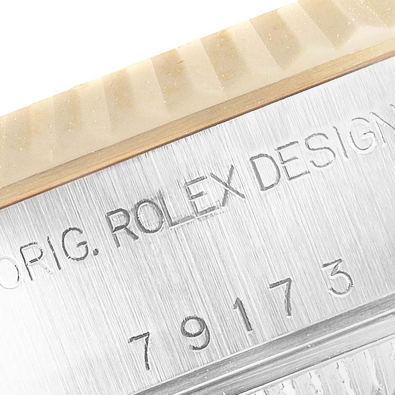 This image shows a close-up of the bezel and case serial number of a Rolex Datejust 79173 Women
s Steel and Gold (two tone) Silver Dial 79173 Women
s Steel and Gold (two tone) Silver Dial watch.