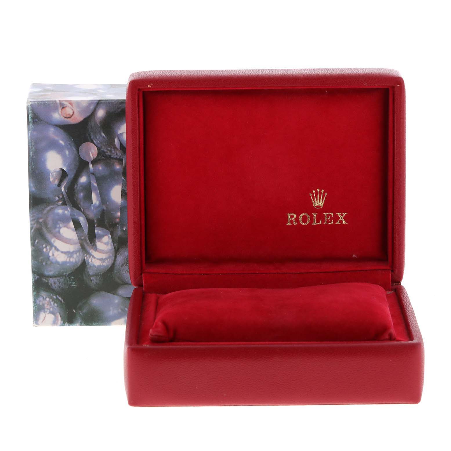 The image shows an open red Rolex watch box, likely for the Datejust model, with a cushion inside and "Rolex" branding.