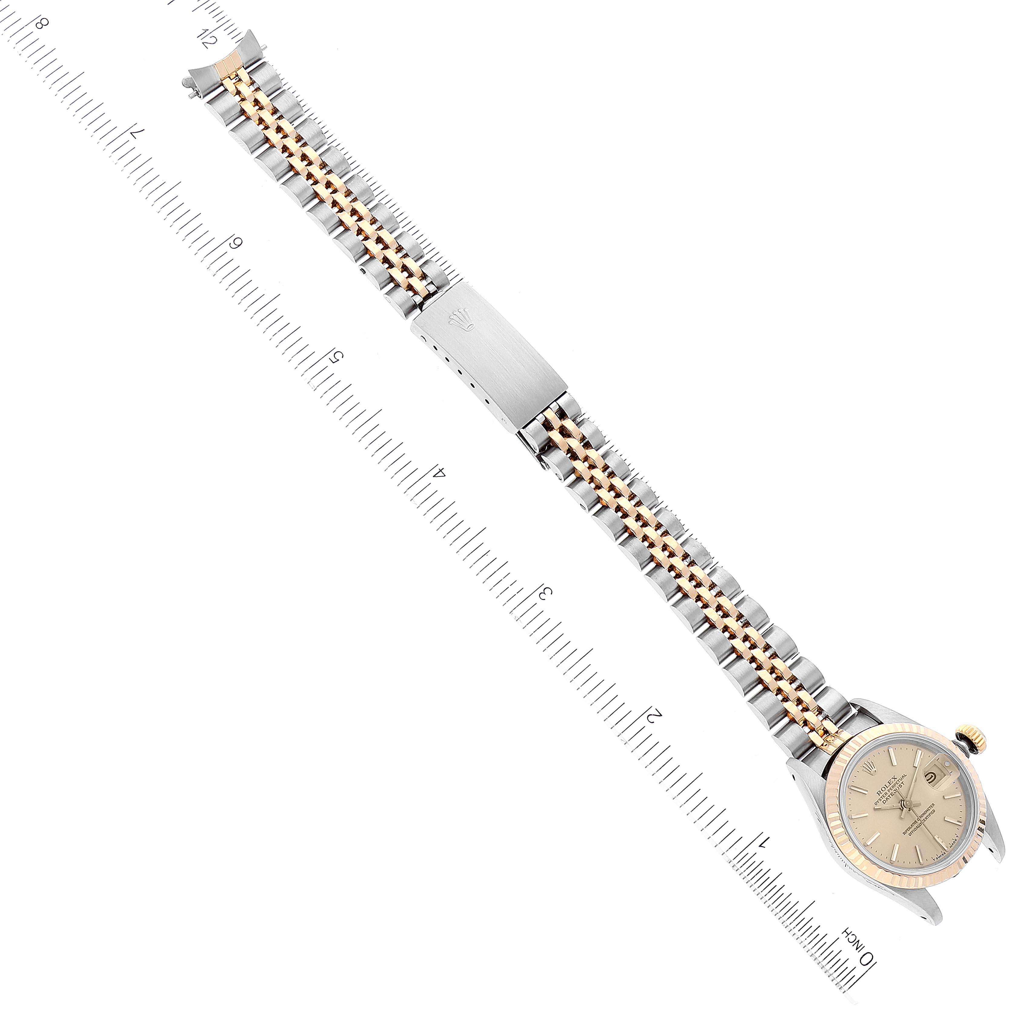 The image shows an overhead view of the Rolex Datejust 69173 Women's Steel and Gold (two tone) Champagne Dial 69173 Women's Steel and Gold (two tone) Champagne Dial watch, highlighting the full bracelet and face with a measuring ruler beside it.