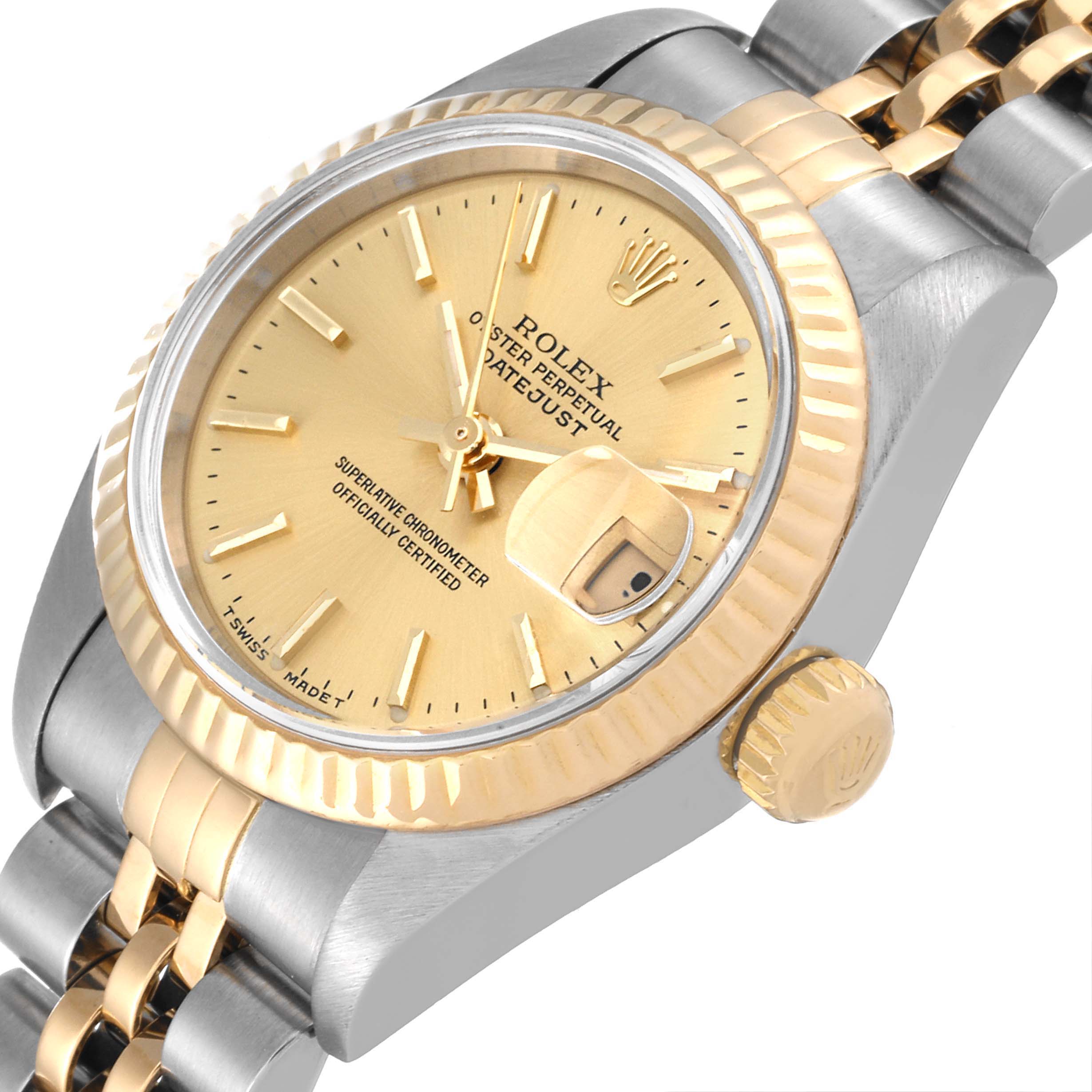 The image shows a close-up of the Rolex Datejust 69173 Women
s Steel and Gold (two tone) Champagne Dial 69173 Women
s Steel and Gold (two tone) Champagne Dial watch
s dial, bezel, crown, and part of the bracelet from a tilted angle.