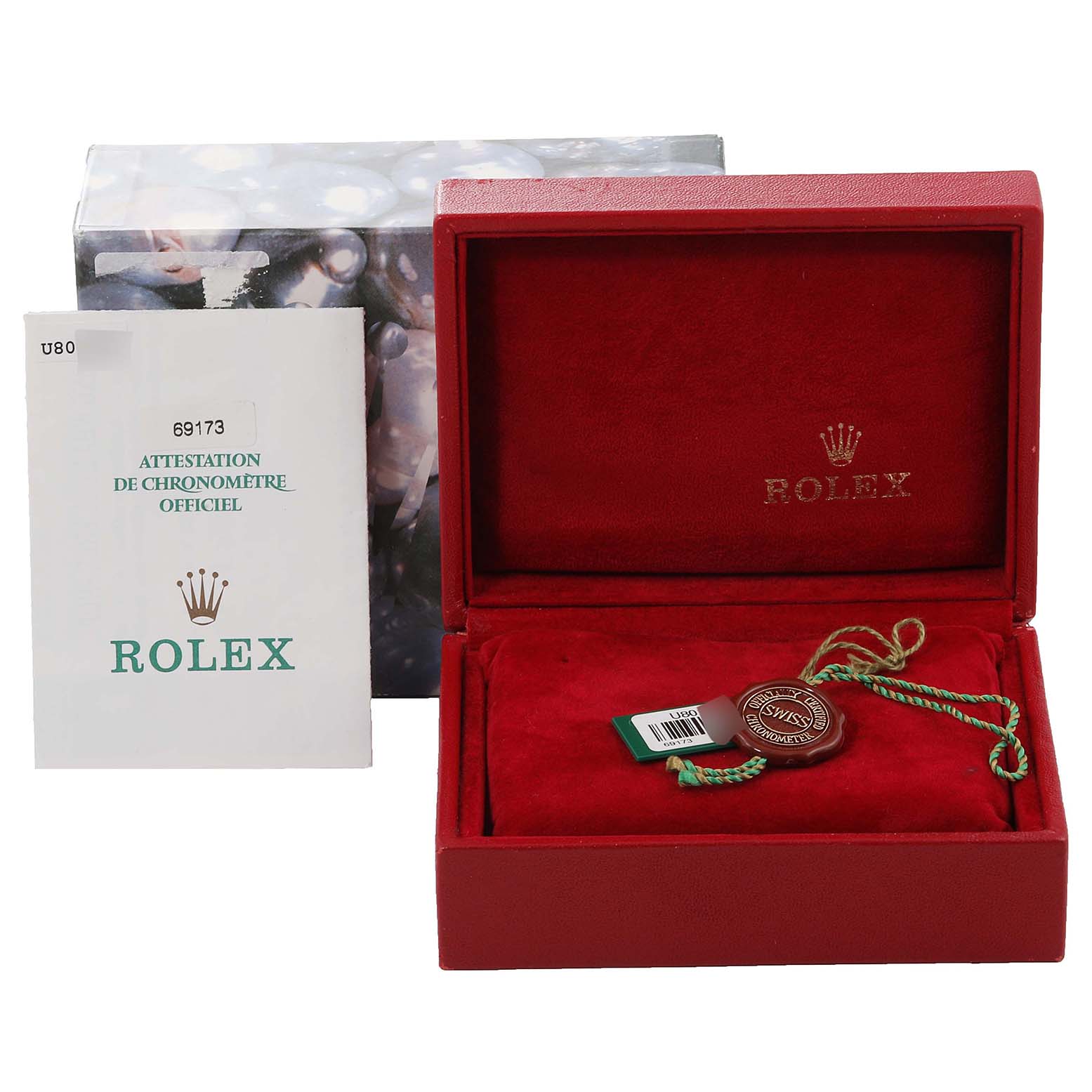 This image shows the packaging and accessories of a Rolex Datejust 69173 Women
s Steel and Gold (two tone) Champagne Dial 69173 Women
s Steel and Gold (two tone) Champagne Dial watch, including the box, warranty booklet, and tag seal.