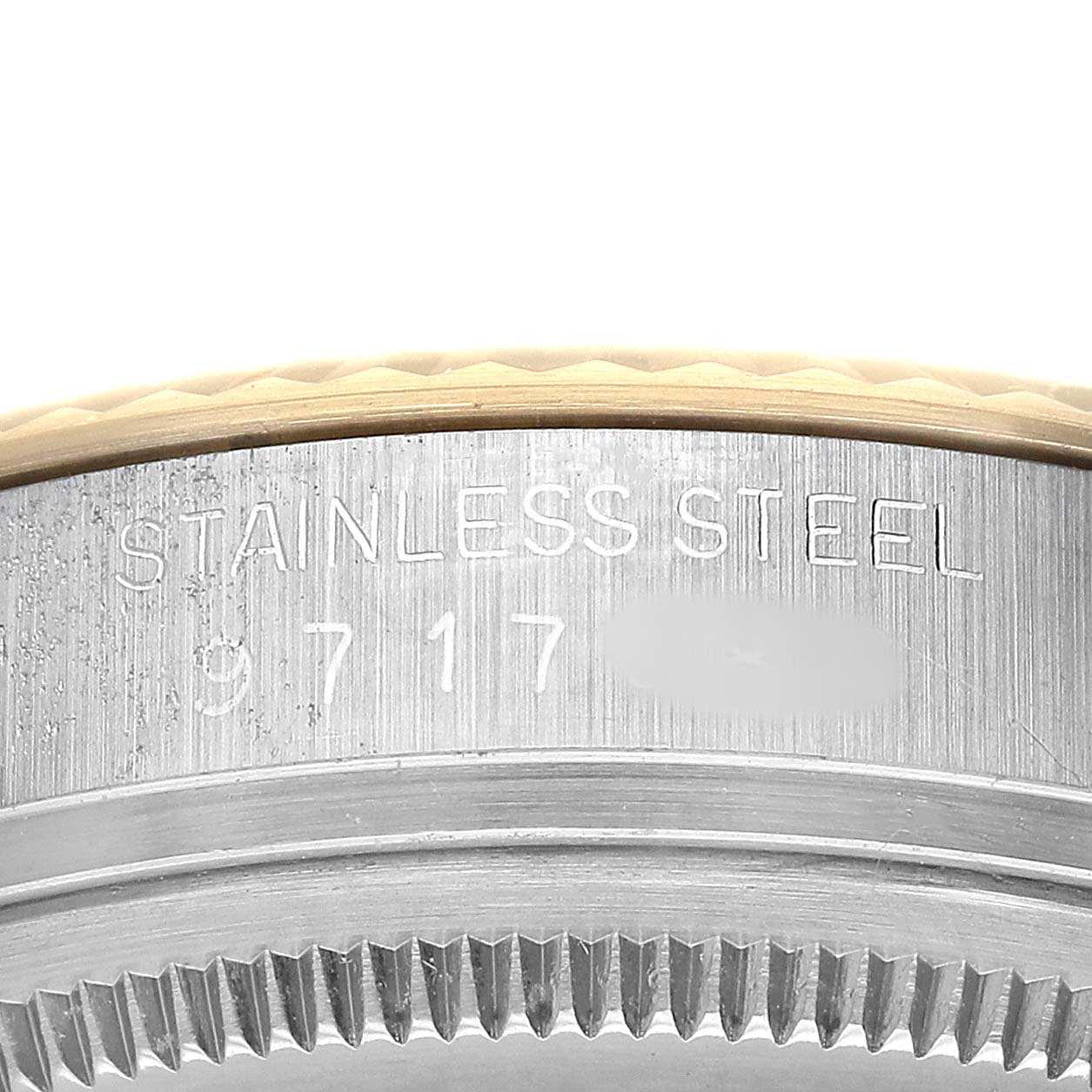 The image shows a close-up of a Rolex Datejust 16013 Men's Steel and Gold (two tone) Champagne Dial model's stainless steel case, specifically the side with engraved details.