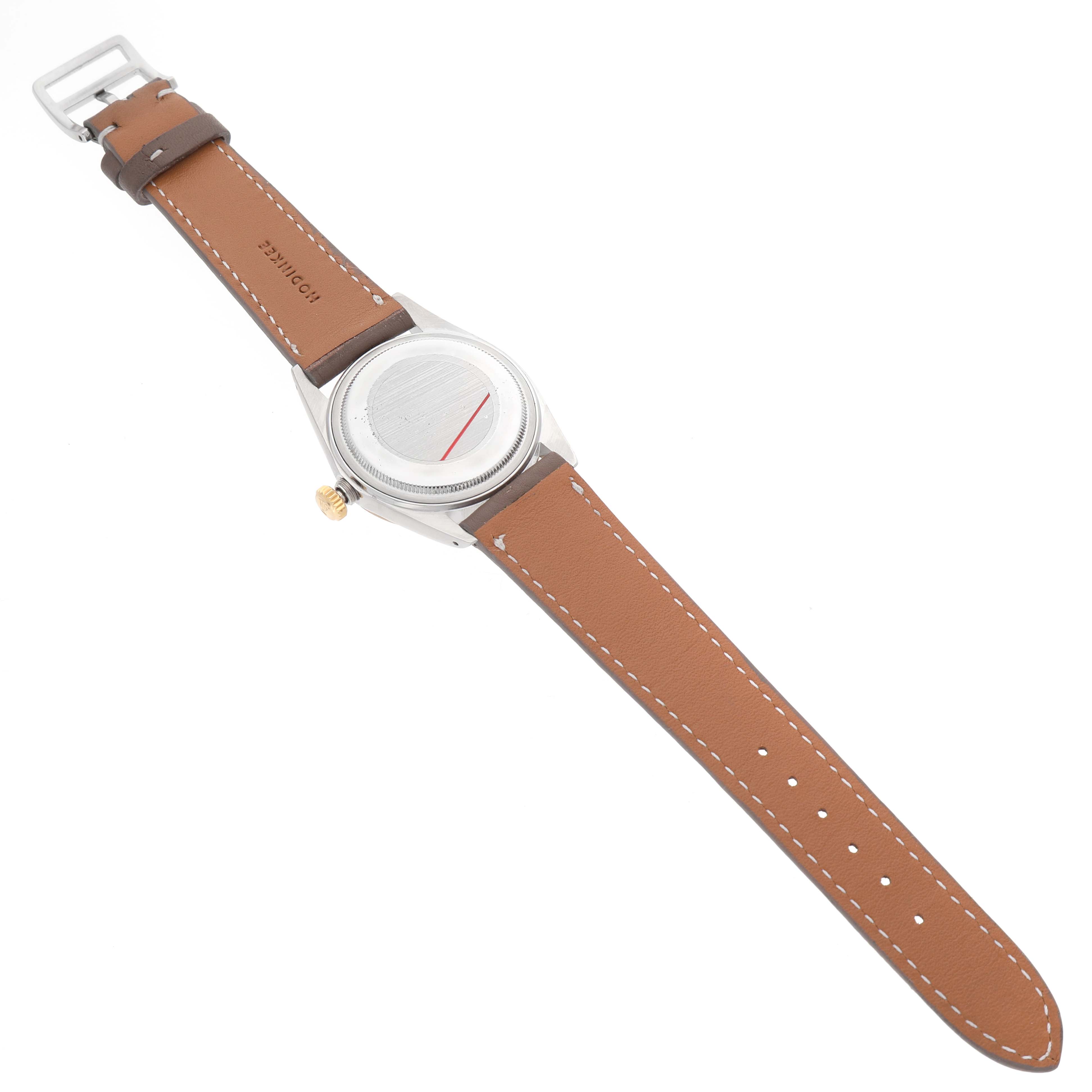 The Rolex Datejust 16013 Men's Steel and Gold (two tone) Champagne Dial watch is shown from the back, displaying the case and a brown leather strap.