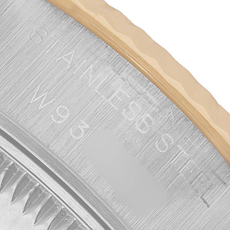 The image shows a close-up of the case engraving on a Rolex Datejust 69173 Women's Steel and Gold (two tone) White Dial, highlighting "STAINLESS STEEL."