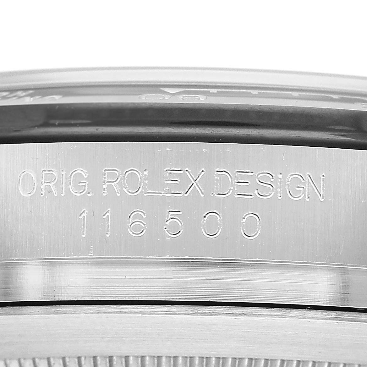The image shows a close-up of the side engraving on a Rolex Daytona M116500LN-0001 Men's Stainless Steel White Dial watch, featuring "ORIG. ROLEX DESIGN" and the model number 116500.