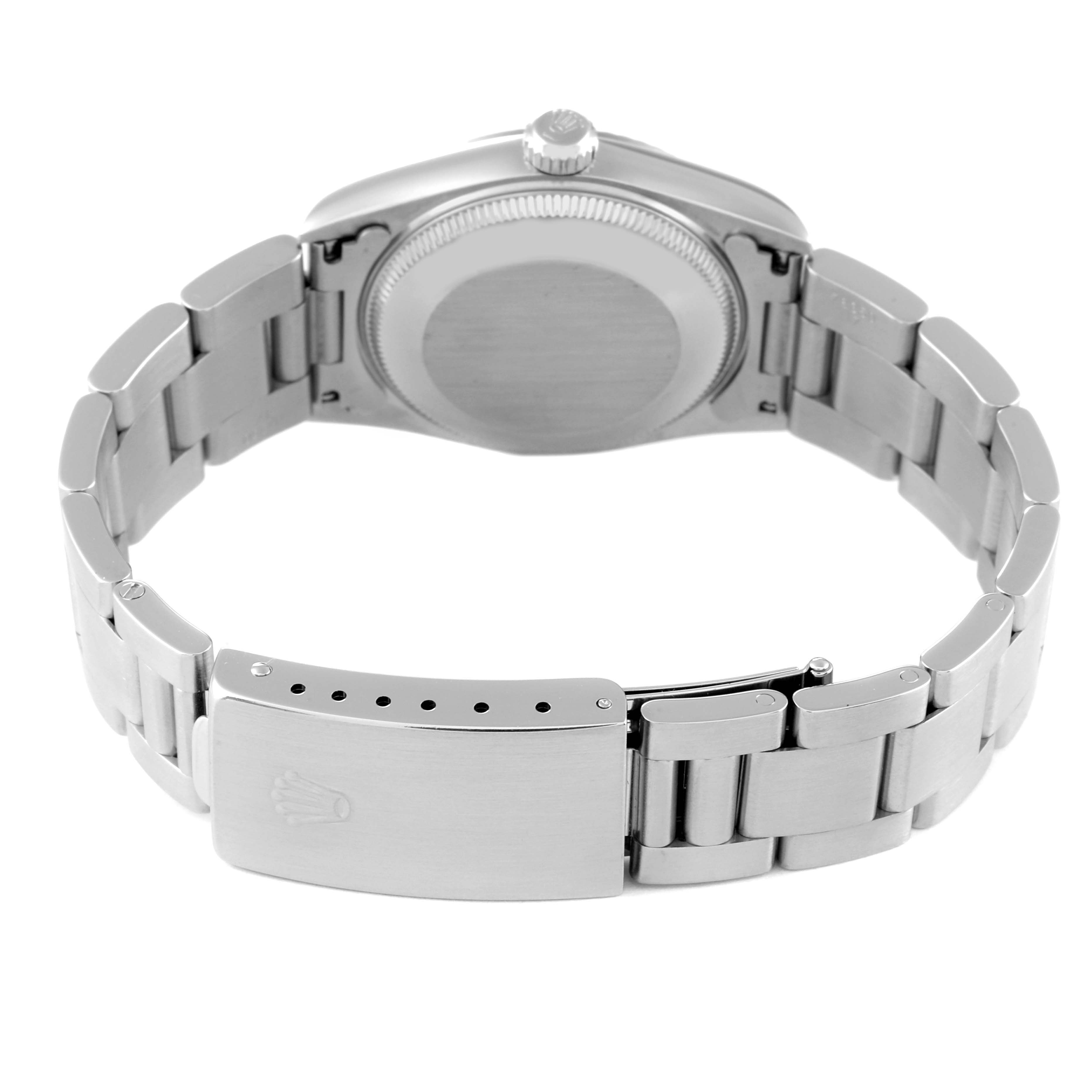 This Rolex Mid-Size 67514 Women
s Stainless Steel Silver Dial 67514 Women
s Stainless Steel Silver Dial watch is shown from the back, displaying the case back, crown, and bracelet with a clasp.