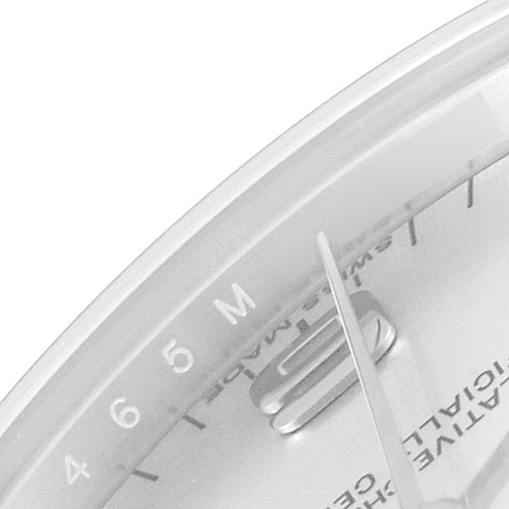 The image shows a close-up of the dial, minute hand, and part of the bezel of a mid-size Rolex watch.