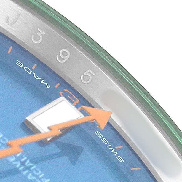 The image shows a close-up of the dial on a Rolex Milgauss 116400GV Men's Stainless Steel Blue Dial, highlighting the orange second hand, numbers, and part of the chapter ring.