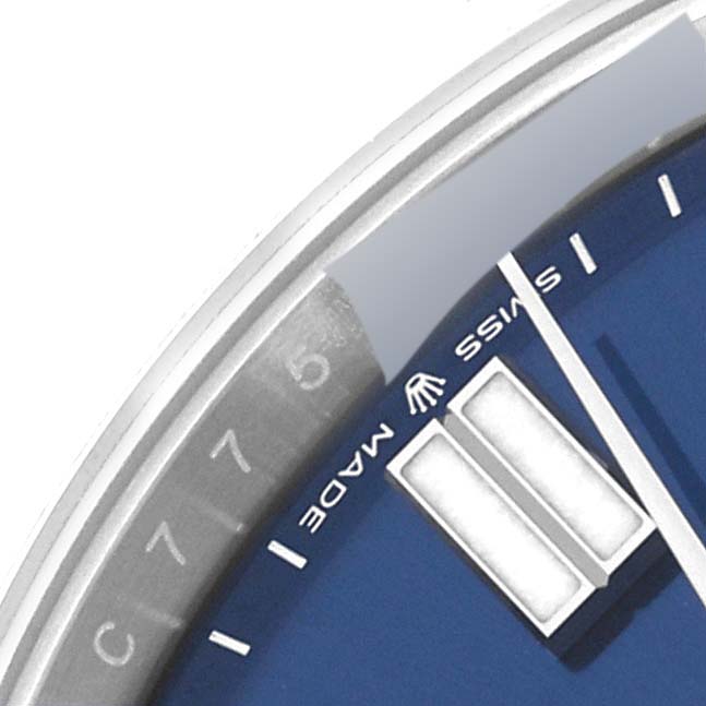 This close-up image shows a partial view of the dial and bezel of a Rolex Oyster Perpetual 124300 Men's Stainless Steel Blue Dial 124300 Men's Stainless Steel Blue Dial watch.