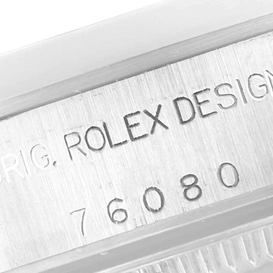 This image shows a close-up of the engraved model number and "ROLEX DESIGN" inscription on the side of the Rolex Oyster Perpetual 76080 Women's Stainless Steel Pink Dial 76080 Women's Stainless Steel Pink Dial watch case.