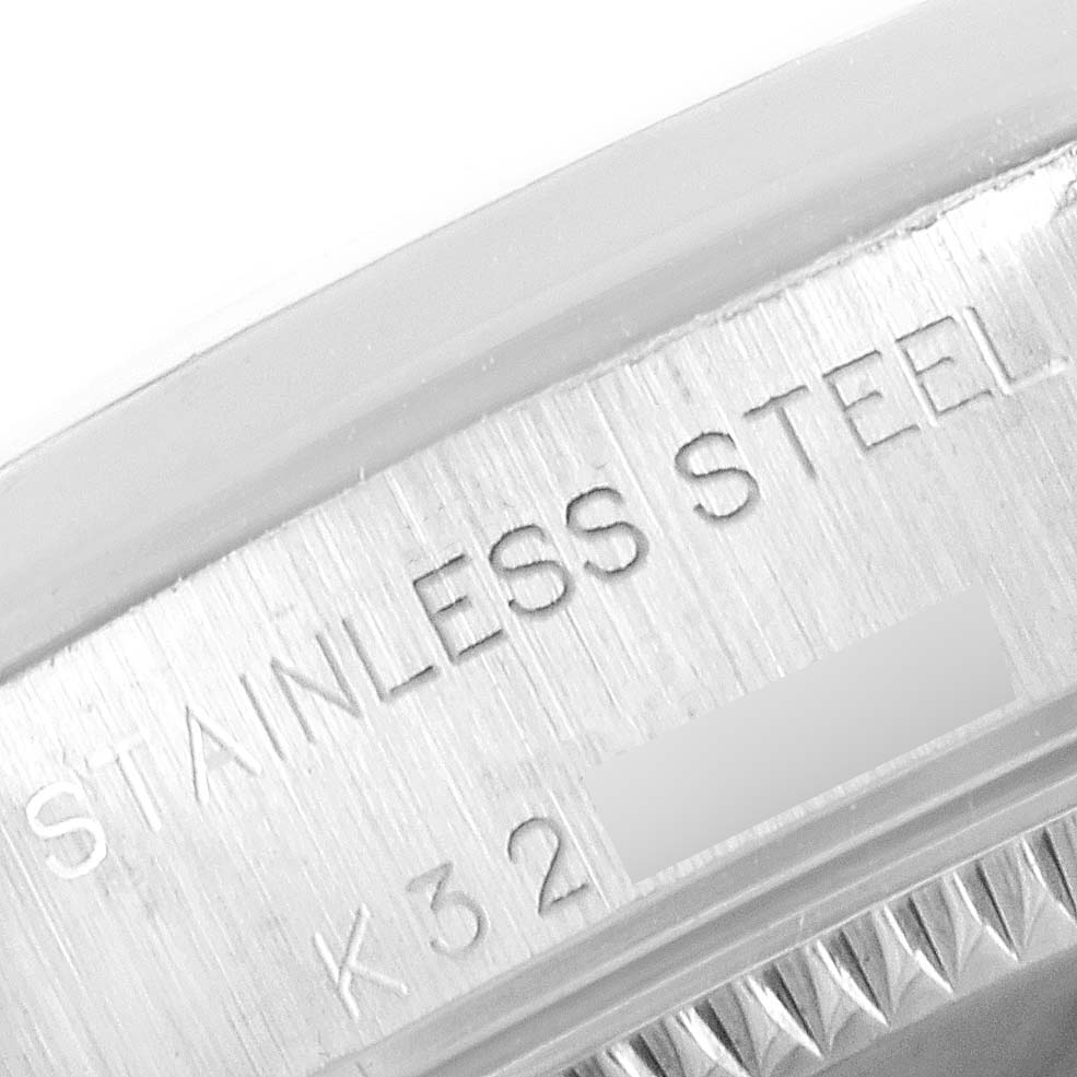 This close-up angle shows part of the case of the Rolex Oyster Perpetual 76080 Women's Stainless Steel Pink Dial 76080 Women's Stainless Steel Pink Dial, highlighting the inscription "STAINLESS STEEL."