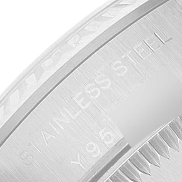 This close-up image shows the stainless steel case back of a Rolex Oyster Perpetual 76094 Women
s Stainless Steel Silver Dial 76094 Women
s Stainless Steel Silver Dial watch.