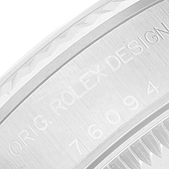 This image shows an angled close-up of the engraved side of a Rolex Oyster Perpetual 76094 Women
s Stainless Steel Silver Dial 76094 Women
s Stainless Steel Silver Dial watch case.