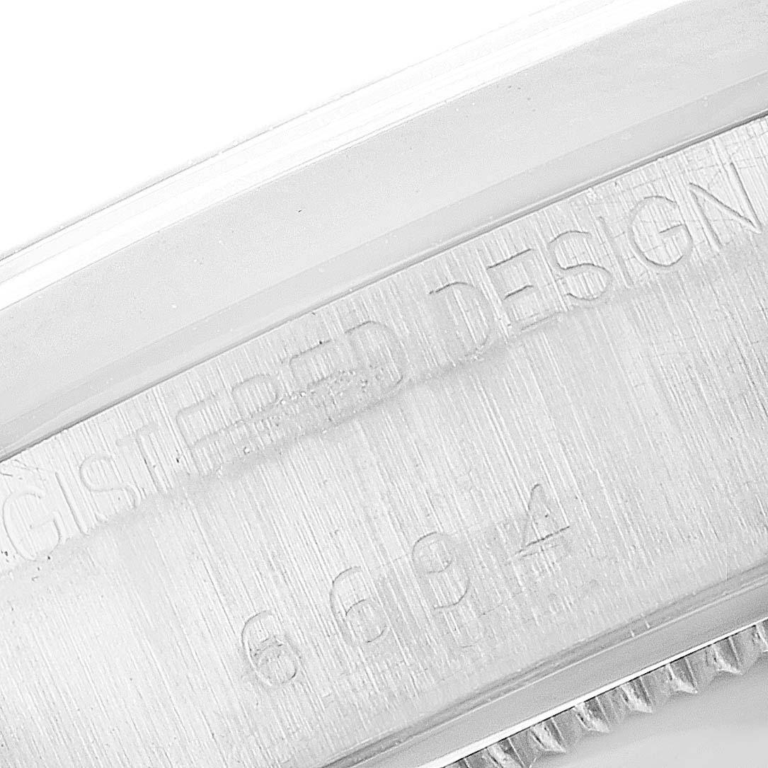 This close-up image shows the side engraving of the Rolex Vintage Collection 6694 Men's Stainless Steel Brown Dial 6694 Men's Stainless Steel Brown Dial watch, focusing on the "Registered Design" marking.