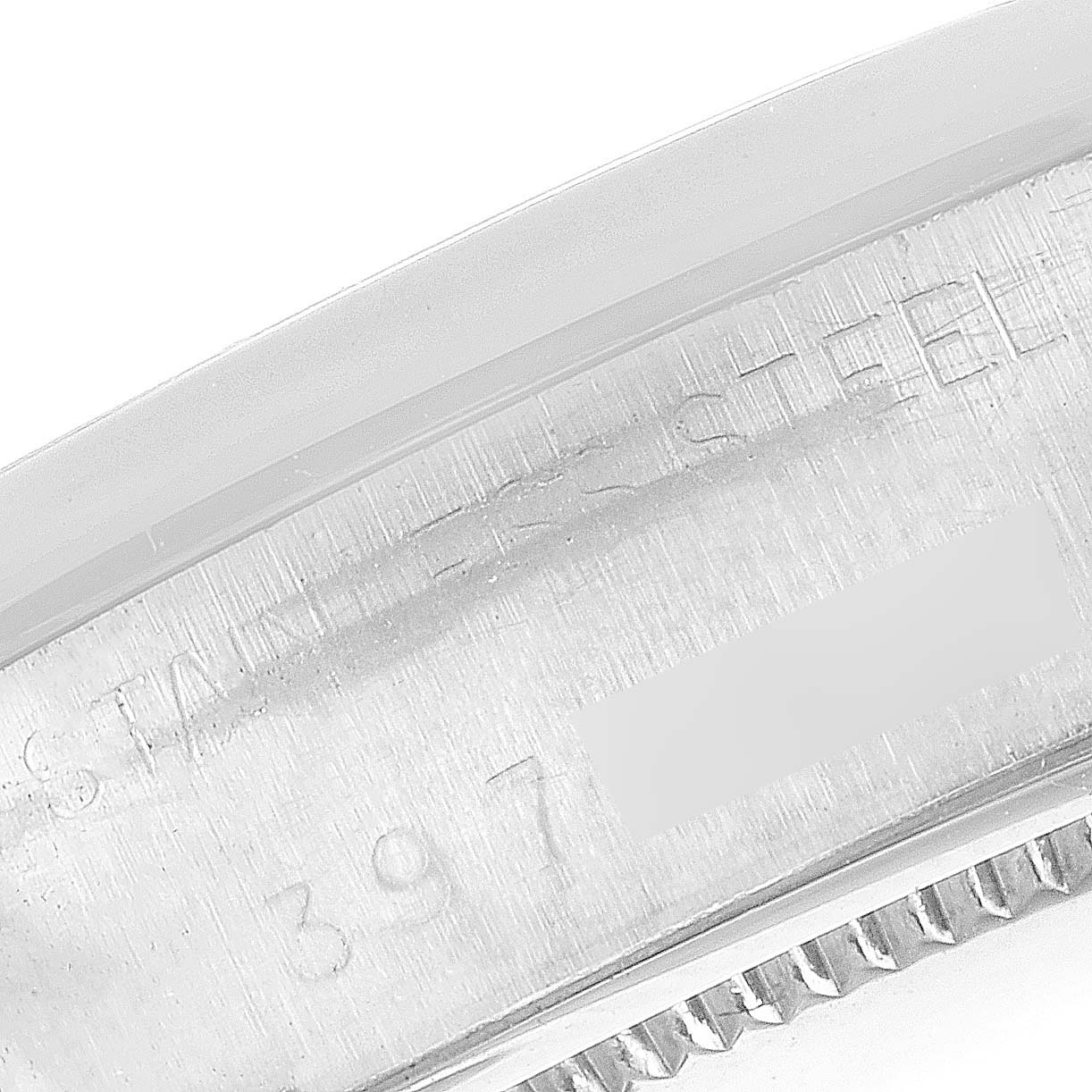 This close-up image shows the engraved edge of the bezel and case back part of a Vintage Collection model by Rolex.