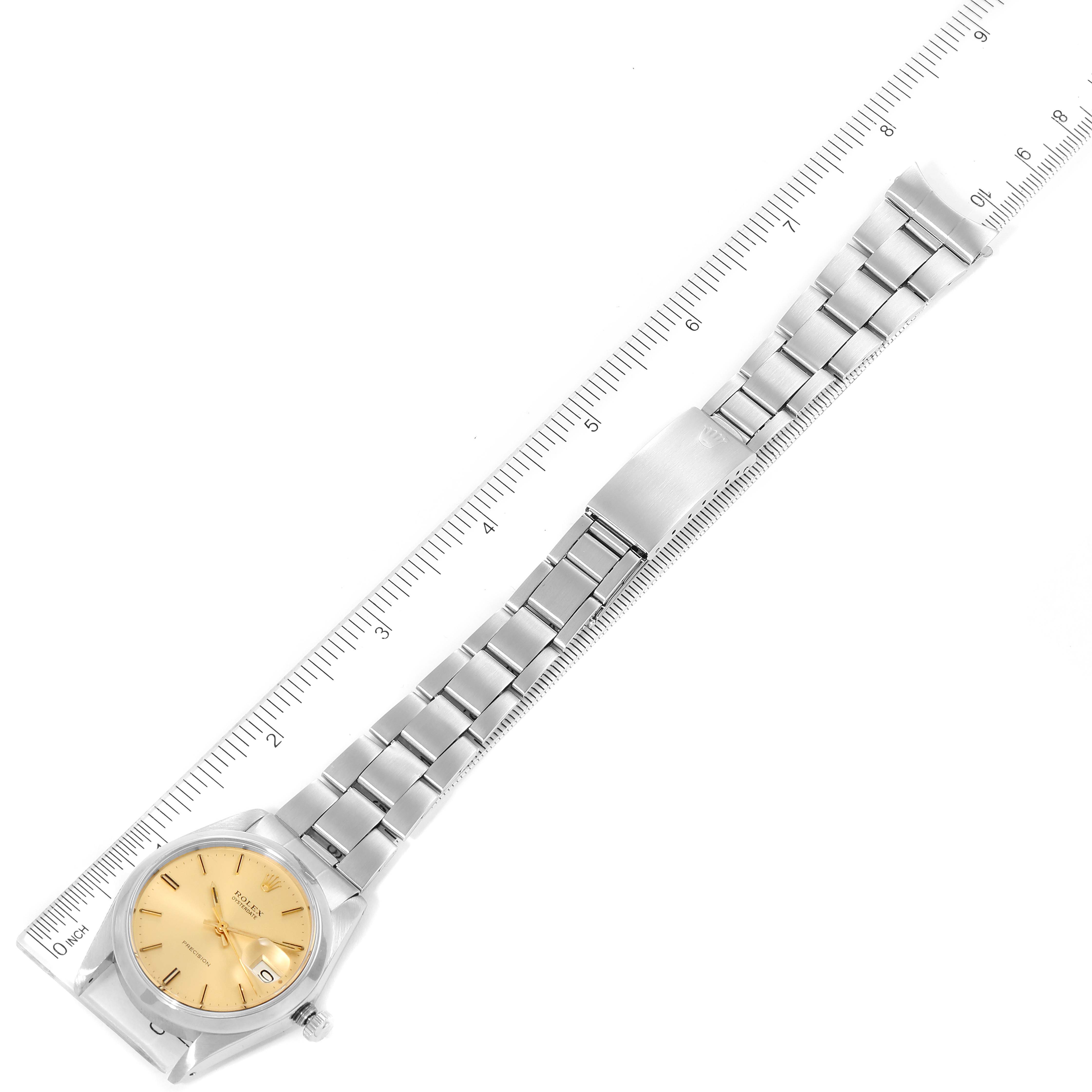 This image shows a Vintage Collection Rolex watch lying flat, featuring a gold-colored dial and a stainless steel bracelet with a ruler for scale.