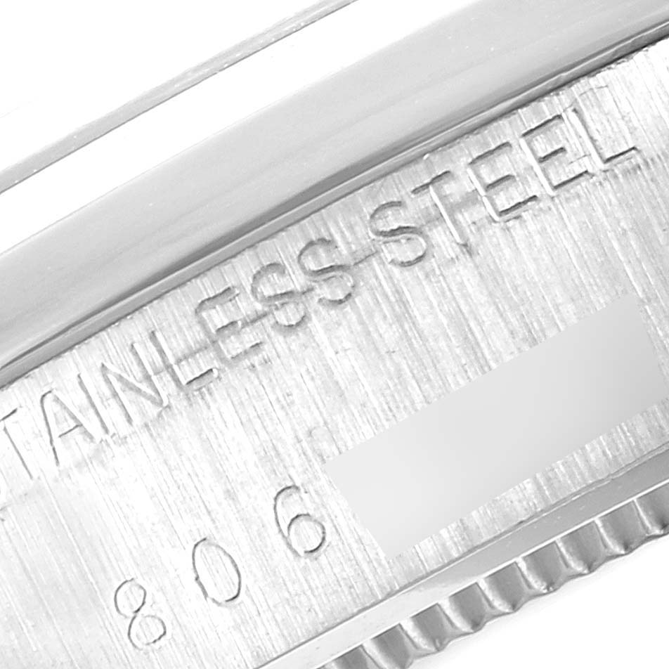 The image shows a close-up of the stainless steel engraving on the case back of a Vintage Collection Rolex watch.