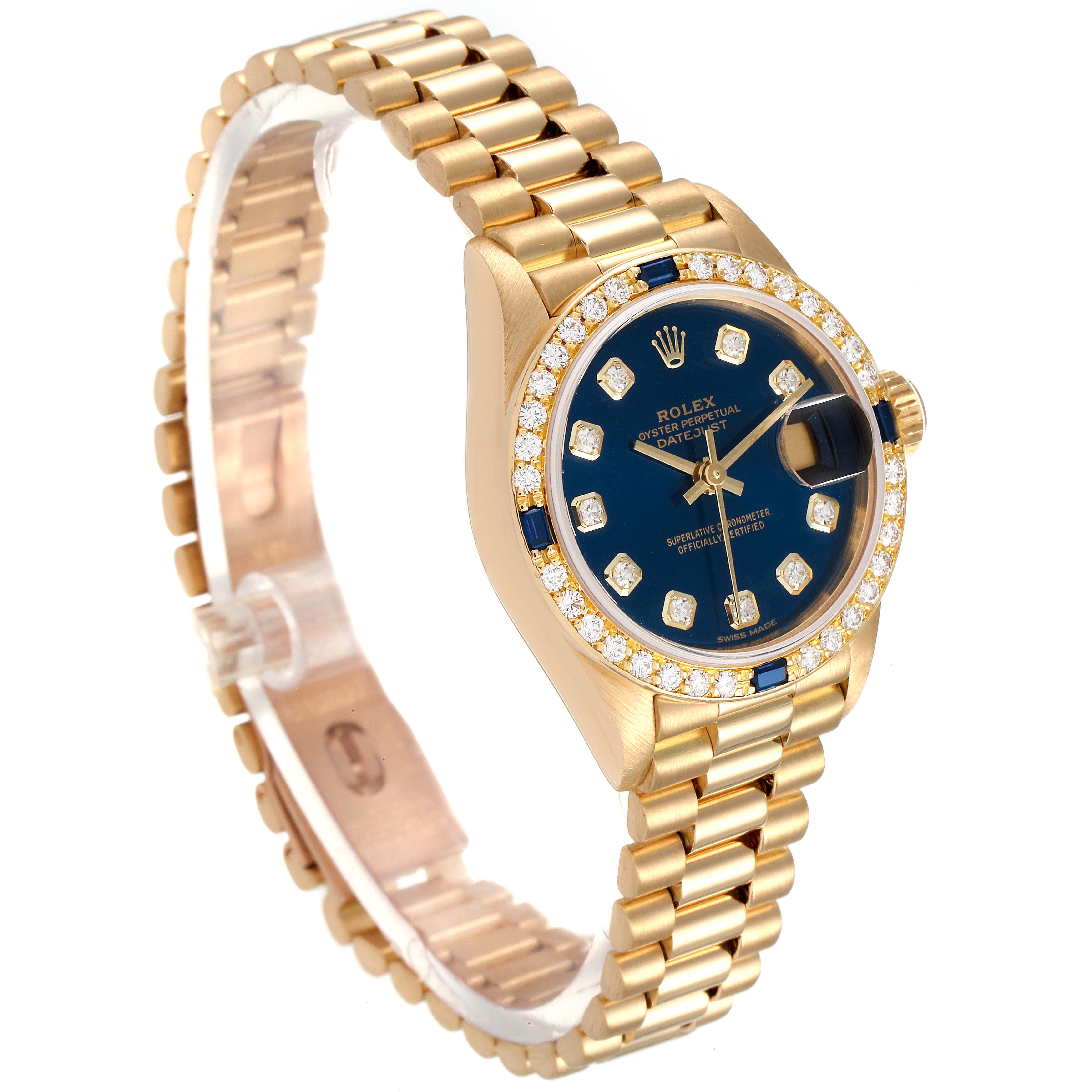 The Rolex President 69088 Women's Yellow Gold Blue Dial 69088 Women's Yellow Gold Blue Dial model watch is shown at a slight angle, with a gold bracelet, blue dial, diamond bezel, and magnified date window.