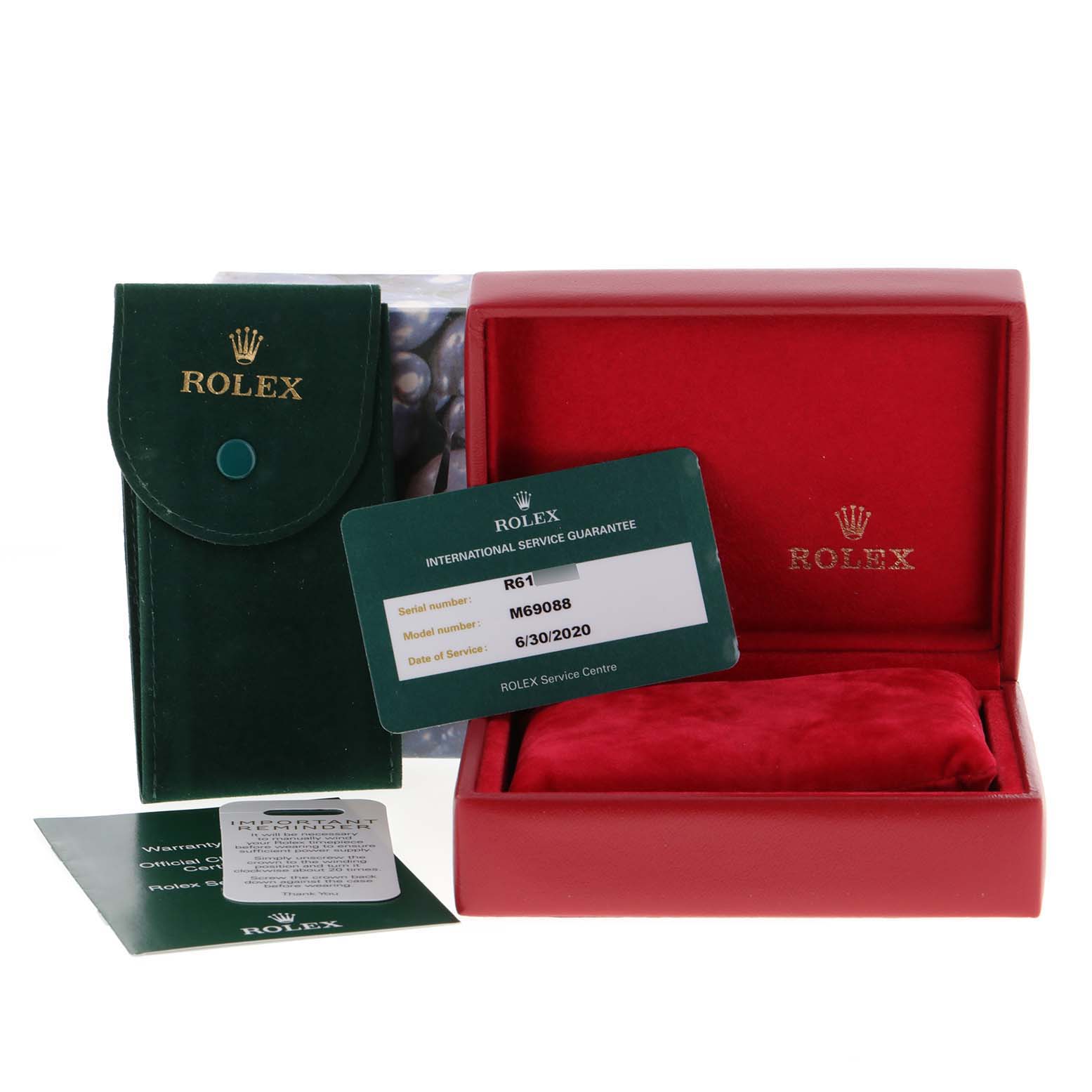 The image shows a Rolex President 69088 Women's Yellow Gold Blue Dial 69088 Women's Yellow Gold Blue Dial watch's packaging, including a green pouch, red box, service guarantee card, and additional documents.
