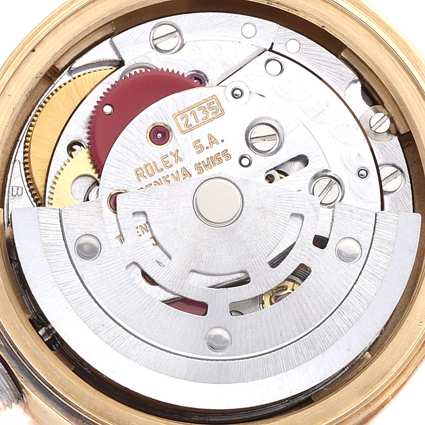 This image shows the intricate inner mechanical movement of a Rolex President 69178 Women's Yellow Gold Red Dial 69178 Women's Yellow Gold Red Dial model watch from a top-down angle.