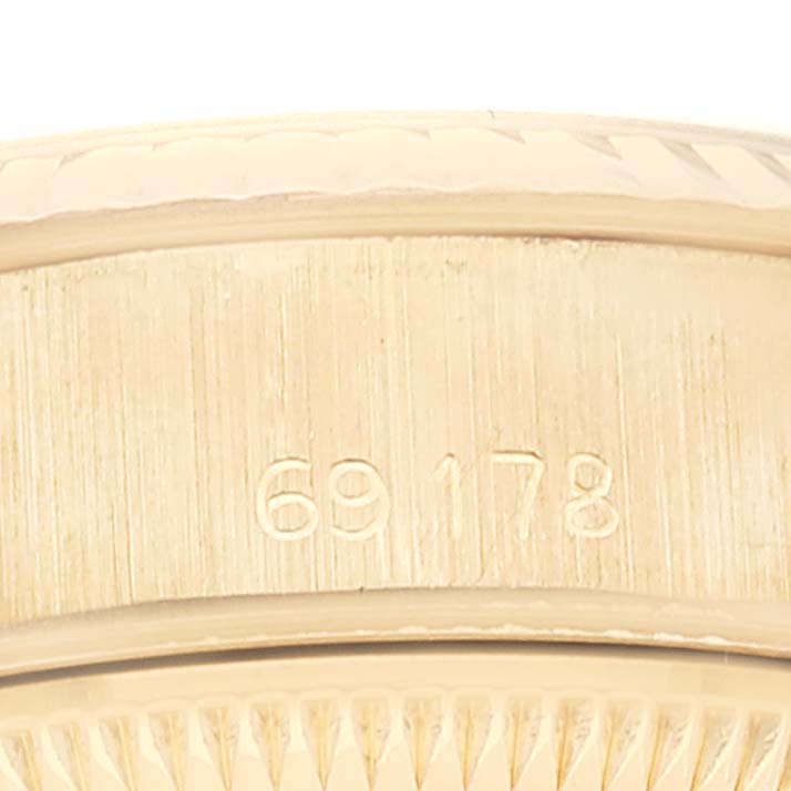 The image shows a close-up of the case side and serial number of a Rolex President 69178 Women's Yellow Gold Red Dial 69178 Women's Yellow Gold Red Dial model watch.