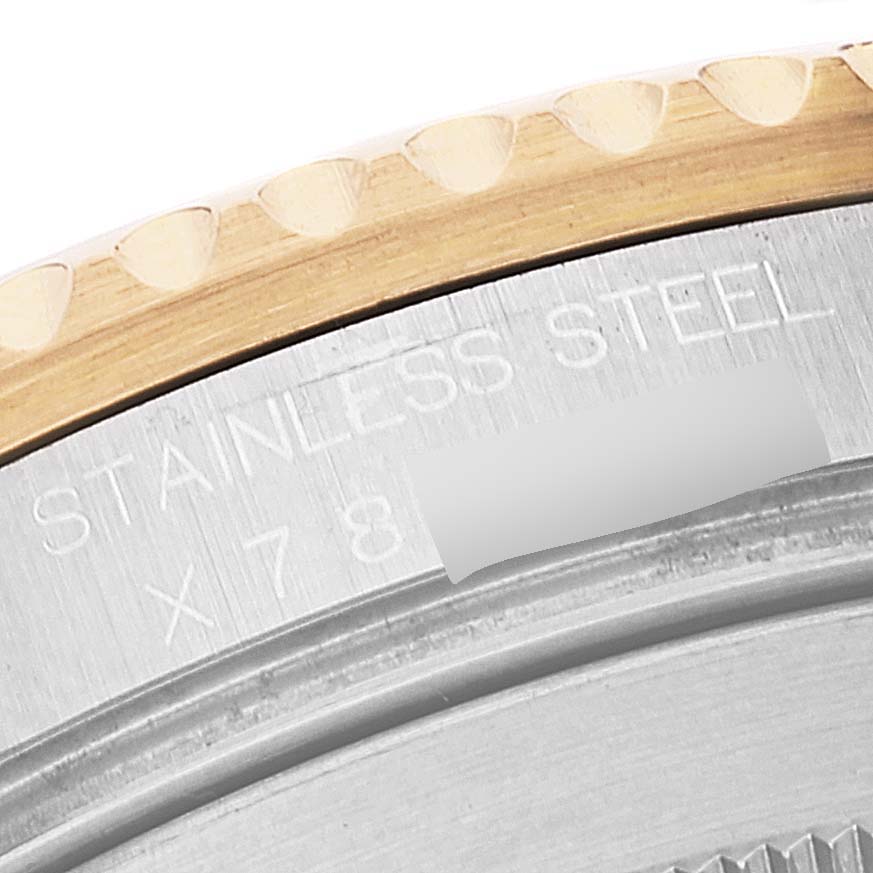 This image shows a close-up of the side of a Rolex Submariner 16613 Men
s Steel and Gold (two tone) Blue Dial 16613 Men
s Steel and Gold (two tone) Blue Dial watch, mainly focusing on the stainless steel part and some of the bezel.