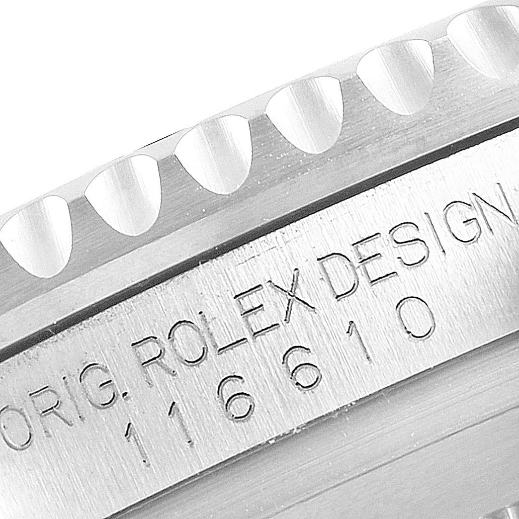 The image shows a close-up of the engraved side of a Rolex Submariner M116610LN-0001 Men's Stainless Steel Black Dial watch, focusing on the case edge and bezel.