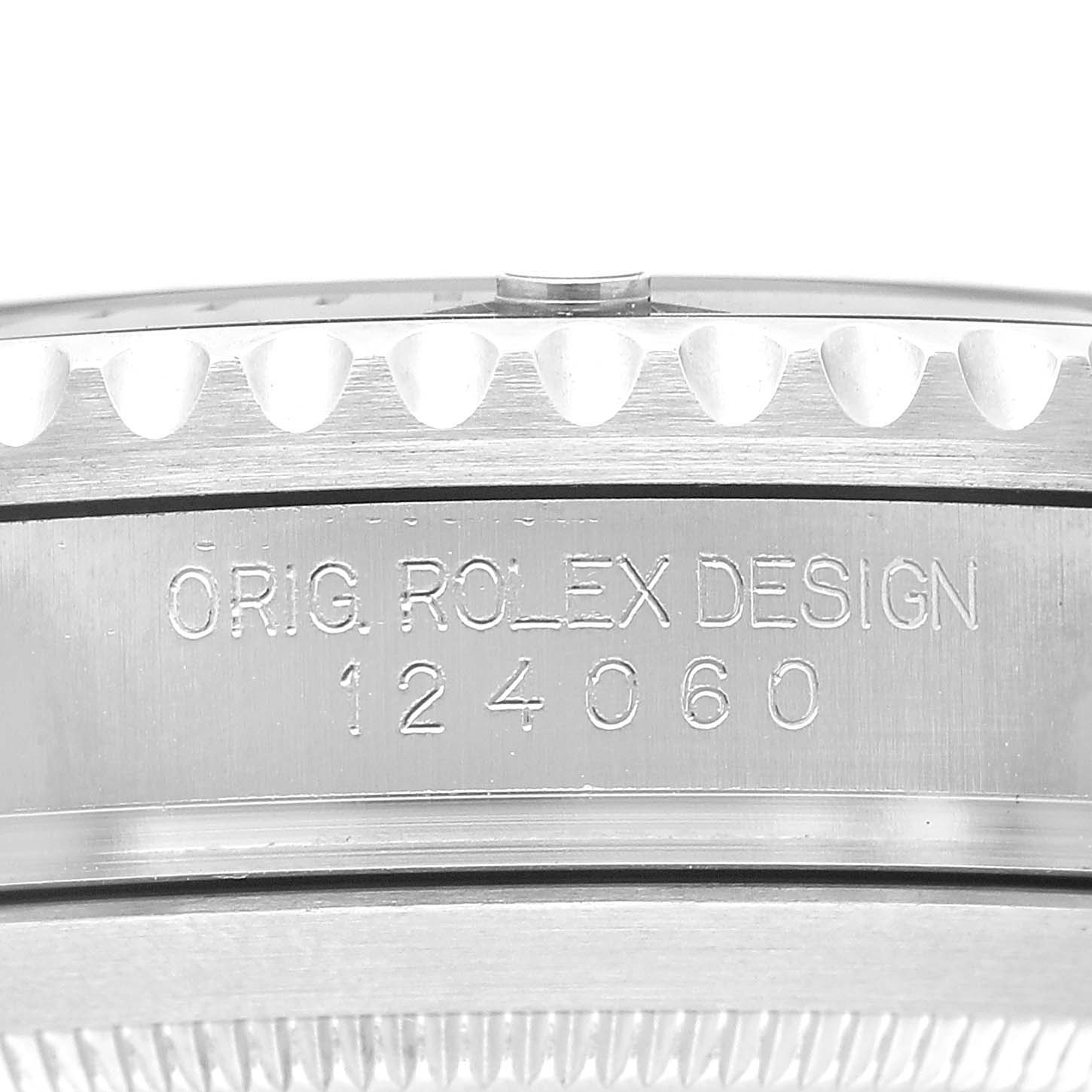 The image shows a close-up of the side of a Rolex Submariner M124060-0001 Men's Stainless Steel Black Dial, featuring the original design engraving and bezel edge.